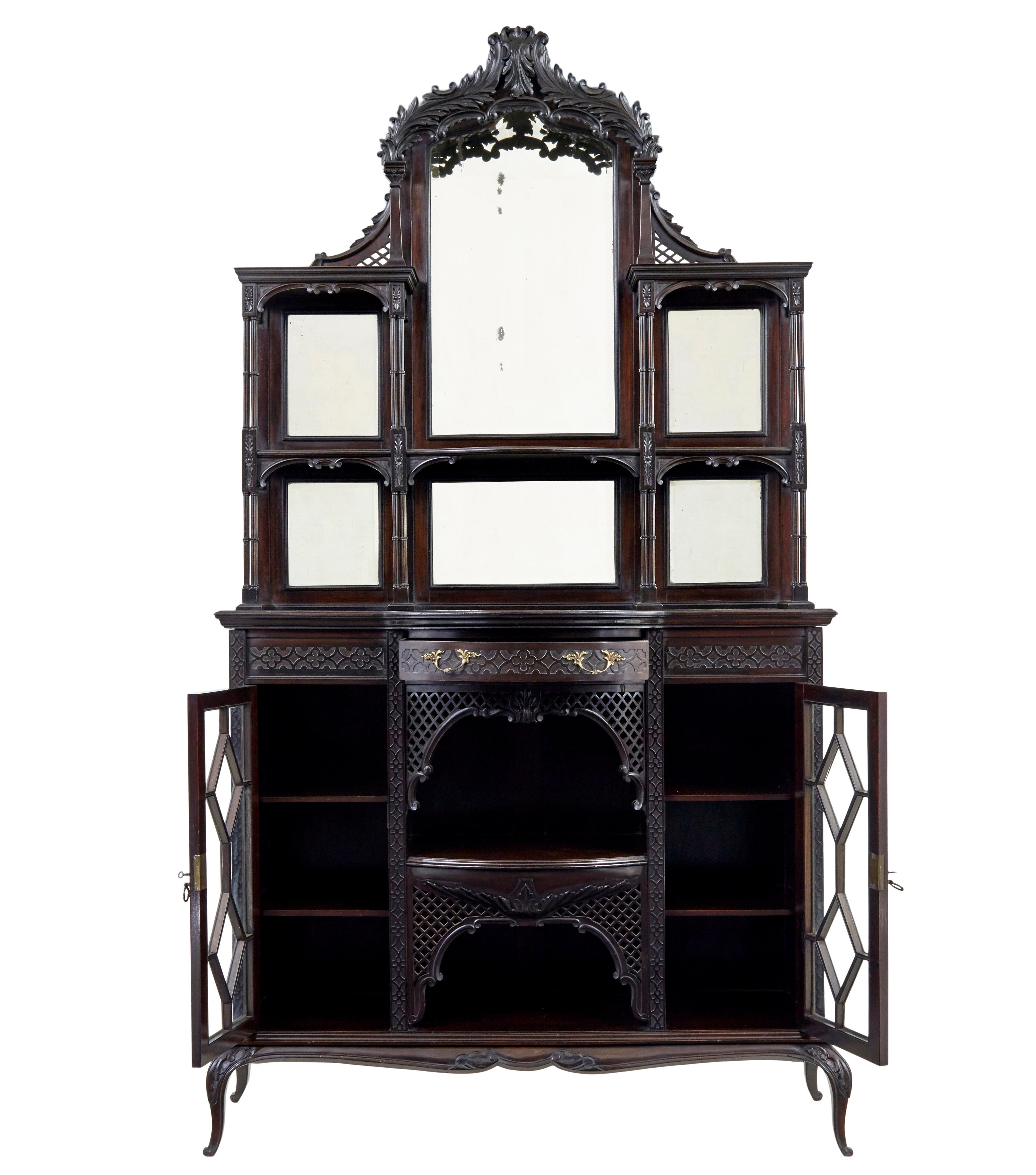 Edwardian Chinese chippendale carved mahogany cabinet, circa 1905.

2 part Edwardian mirrored cabinet in the chippendale taste. Top section comprising of 6 mirrors surmounted by carved latice canopy. Tiers linked together by quad turned columns.
