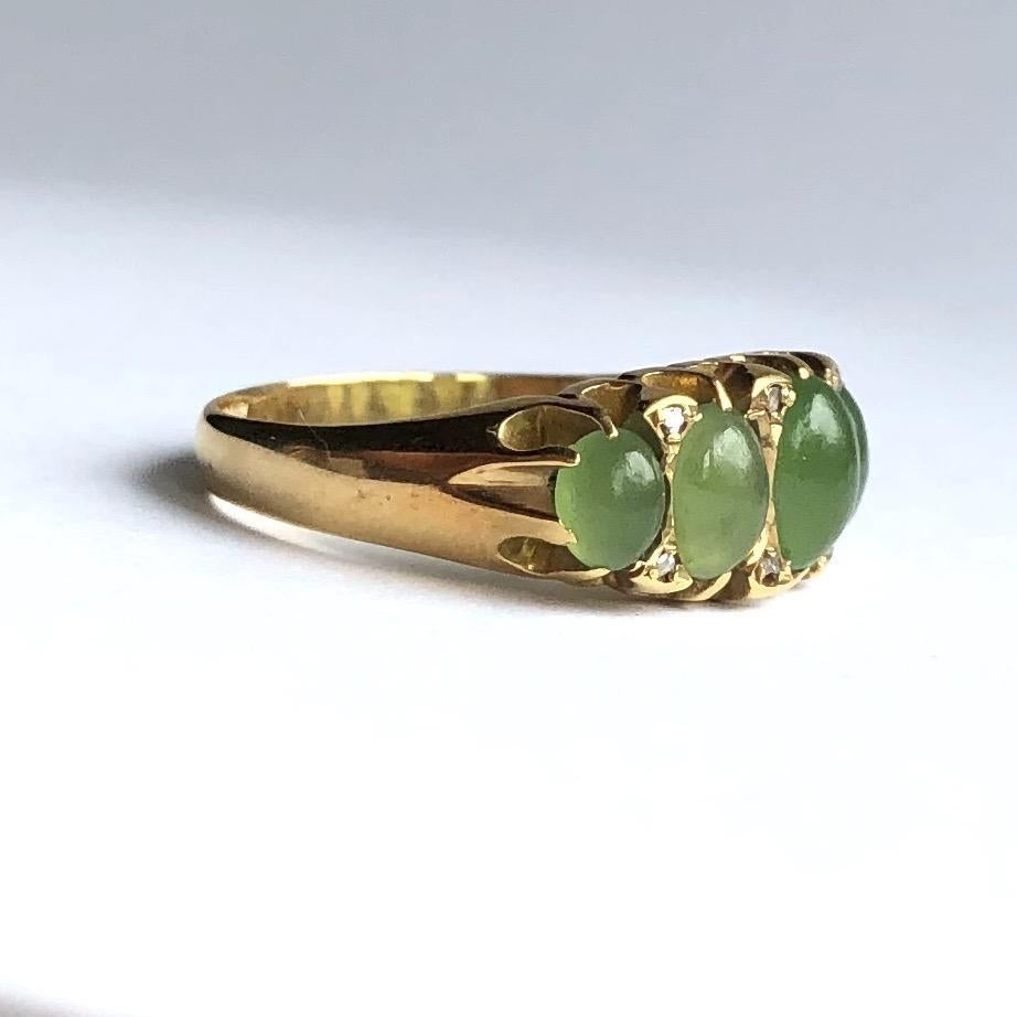 The chrysoprase stones set within this ring are so glossy and complemented by a hint of sparkle with rose cut diamond points. The gallery has scroll detail and the ring is modelled in 18ct gold.

Ring Size: M or 6 1/4
Band Width: 7mm
Height From