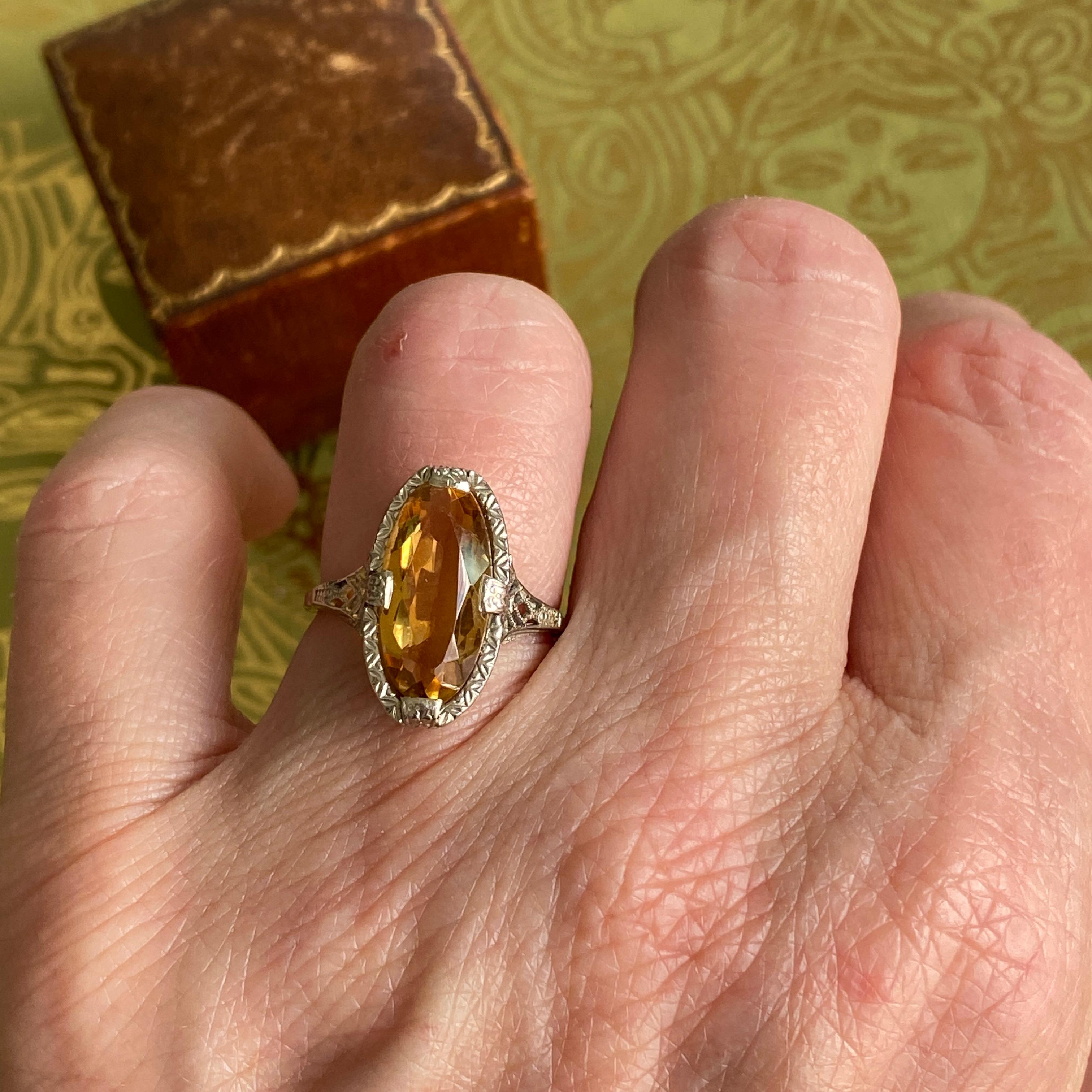 Details:
Beautiful Antique Edwardian era Marquise Citrine set in white 14K gold with filigree and detailed engraving along the setting. A sweet ring, that has a dramatic marquise shape. The citrine has a gorgeous warm golden orange color. The ring