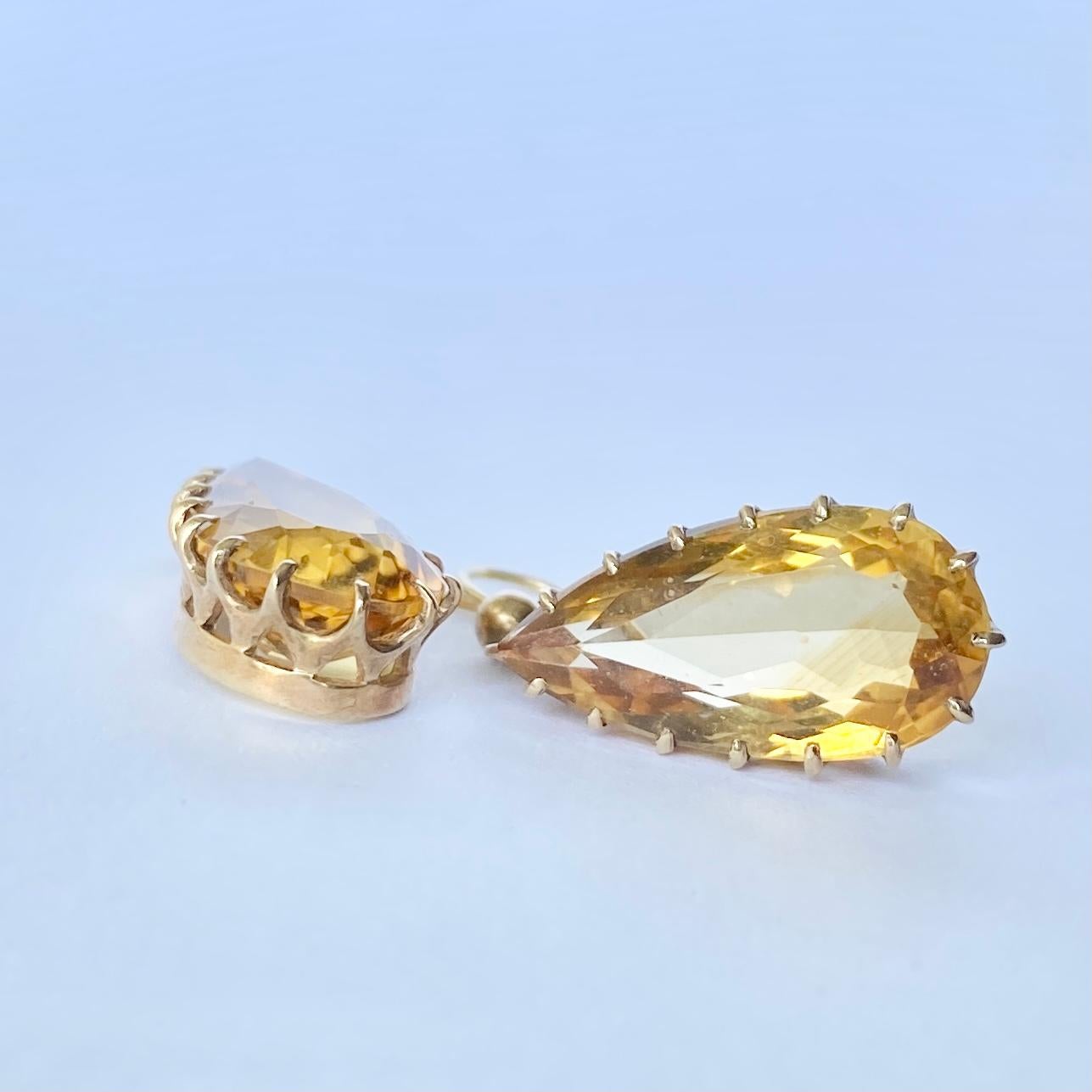 These gorgeous drop earrings feature a gorgeous bright pear drop citrine stone. The stones are encased in gold and attached using a shepherds hook.

Drop from ear: 32mm 

Weight: 4.2g