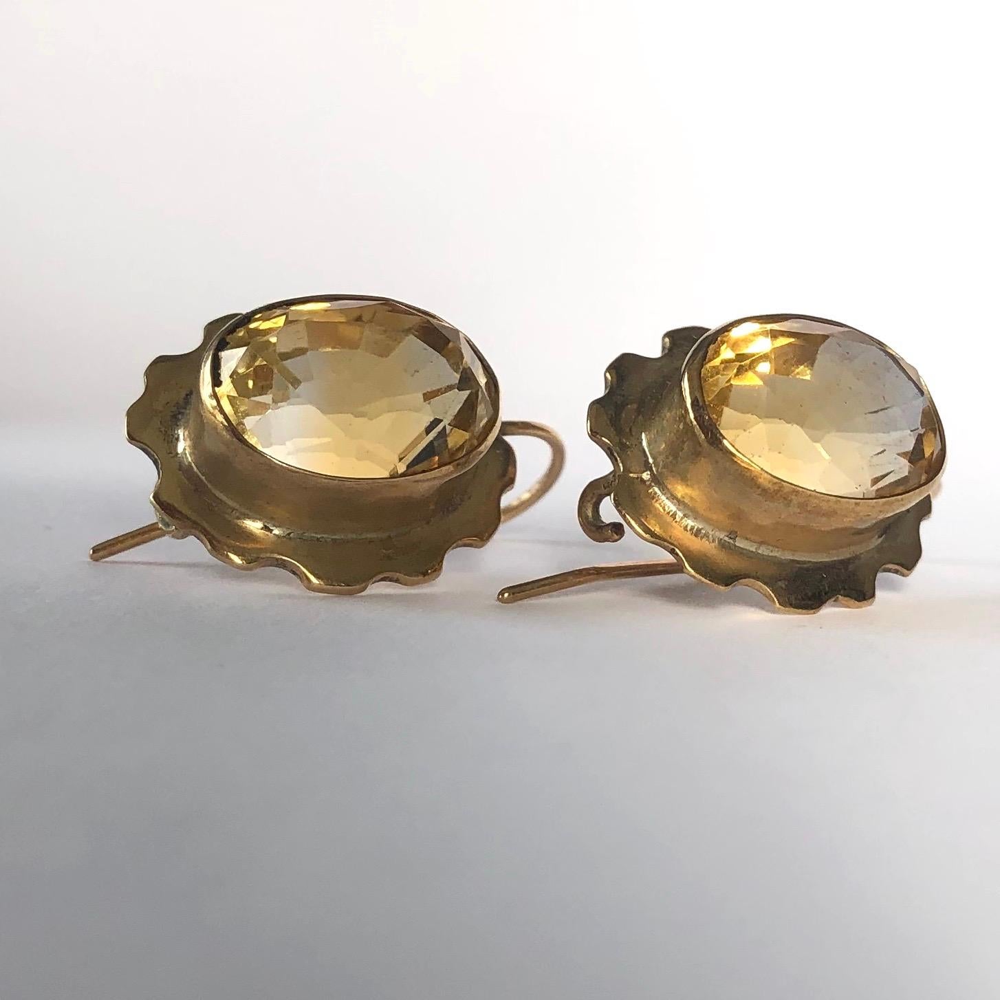 The citrine stones that are set in this glossy 9ct gold are a wonderful yellow colour. The frame around the stones has scalloped detail and they are worn using a shepherds hook. 

Drop From Ear: 22mm
Stone Dimensions: 13x9mm

Weight: 5.99g
