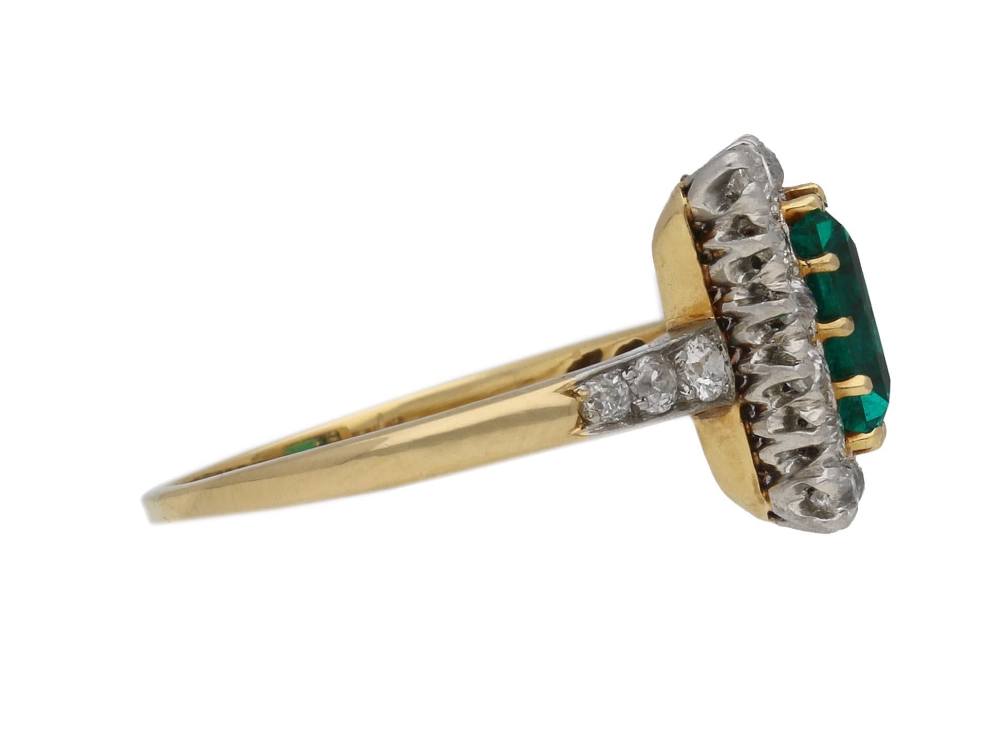 Edwardian Colombian emerald and diamond coronet cluster ring. Set to centre with a rectangular emerald-cut natural Colombian emerald with no colour enhancement and no clarity enhancement in an open back claw setting with an approximate weight of