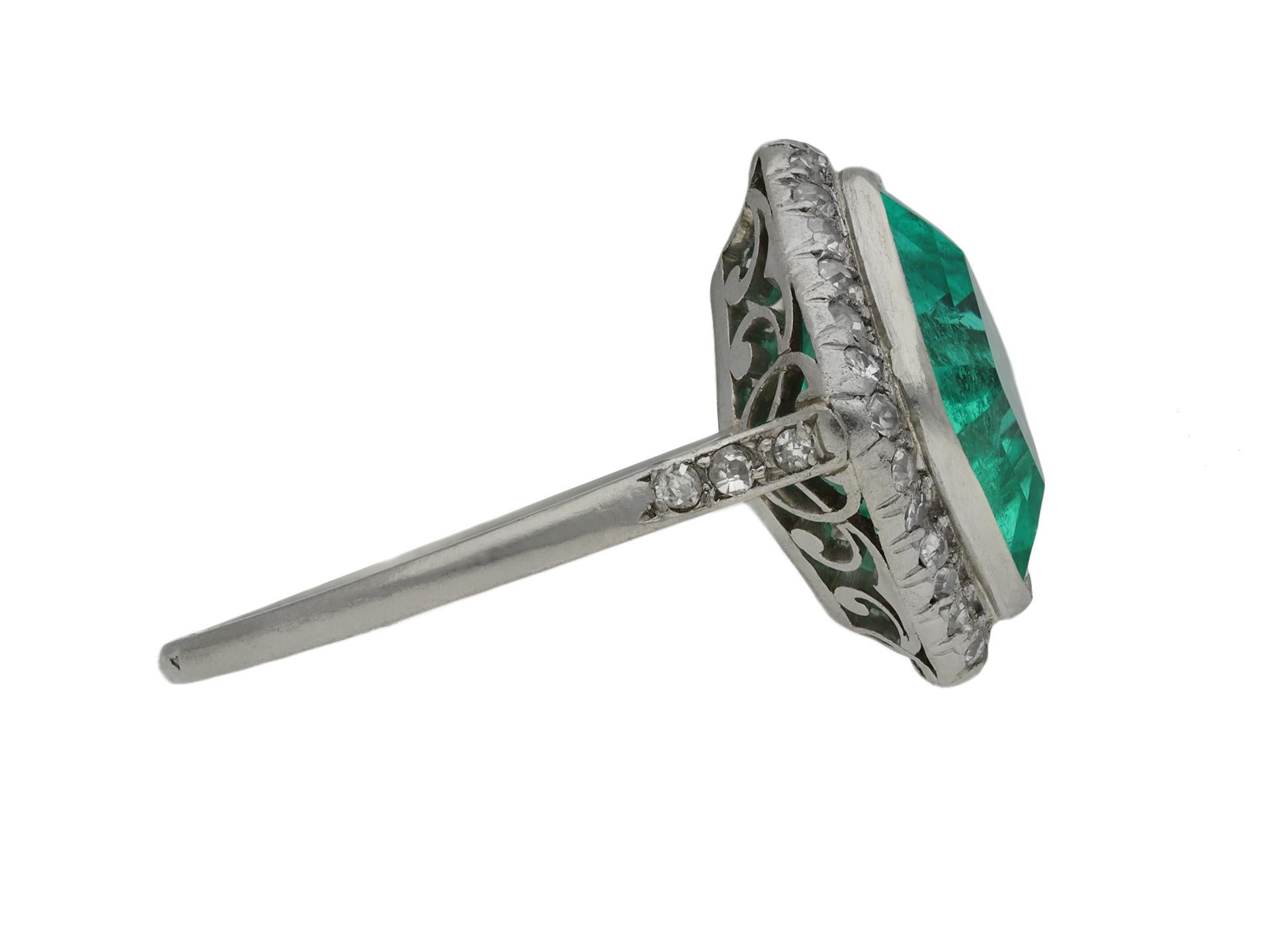 Edwardian Colombian emerald and diamond coronet cluster ring. Set to centre with an octagonal emerald-cut natural Colombian emerald with no colour enhancement and minor clarity enhancement in an open back rubover setting with an approximate weight