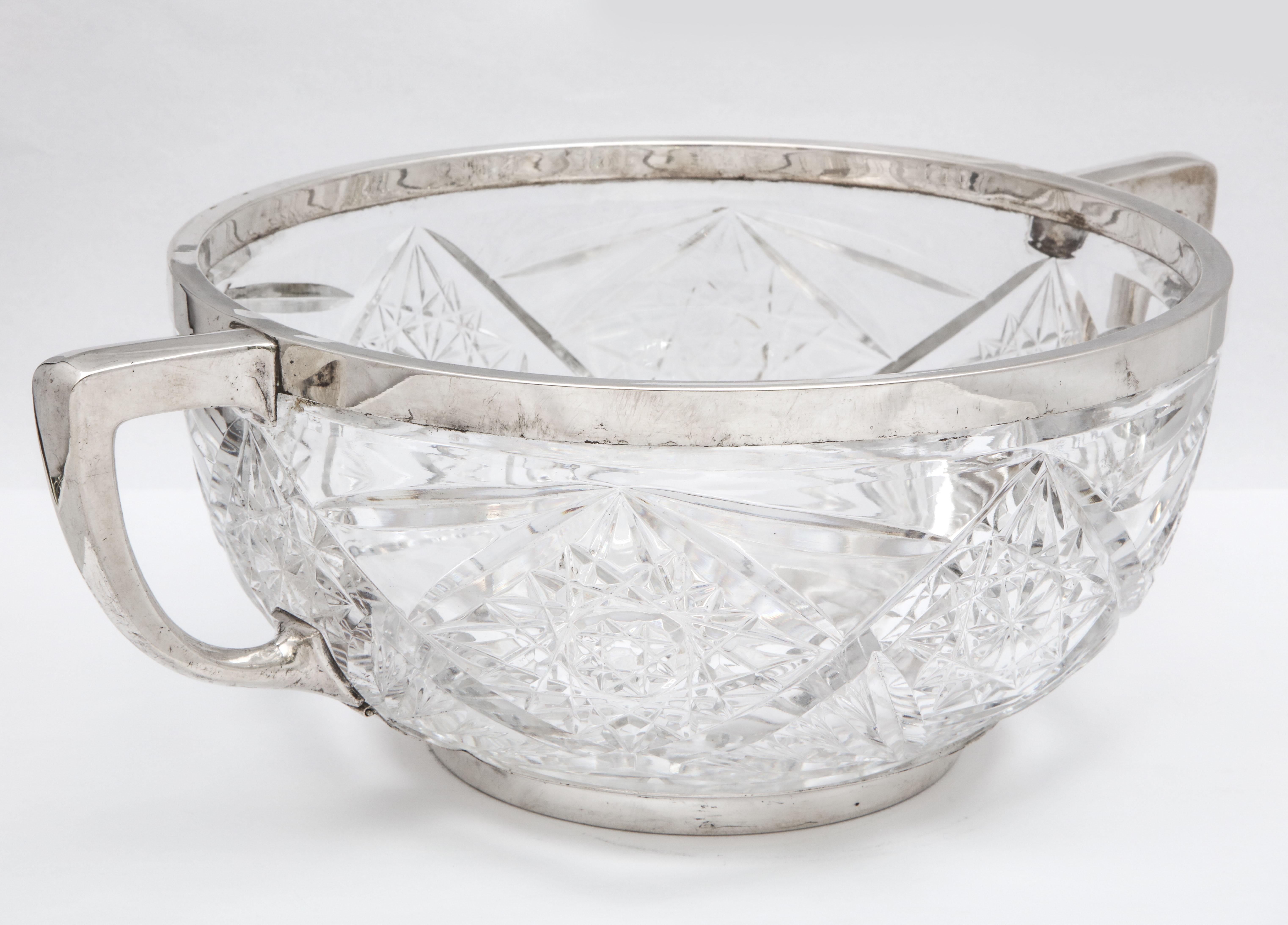 Edwardian period, Continental silver-mounted centerpiece bowl, Germany, circa 1910, Deyhle Gebruder-Schwabish Gmund - maker. Silver mount is removable. Measures 14 inches wide (handle to handle) x 10 inches diameter x 5 inches high. Dark spots in