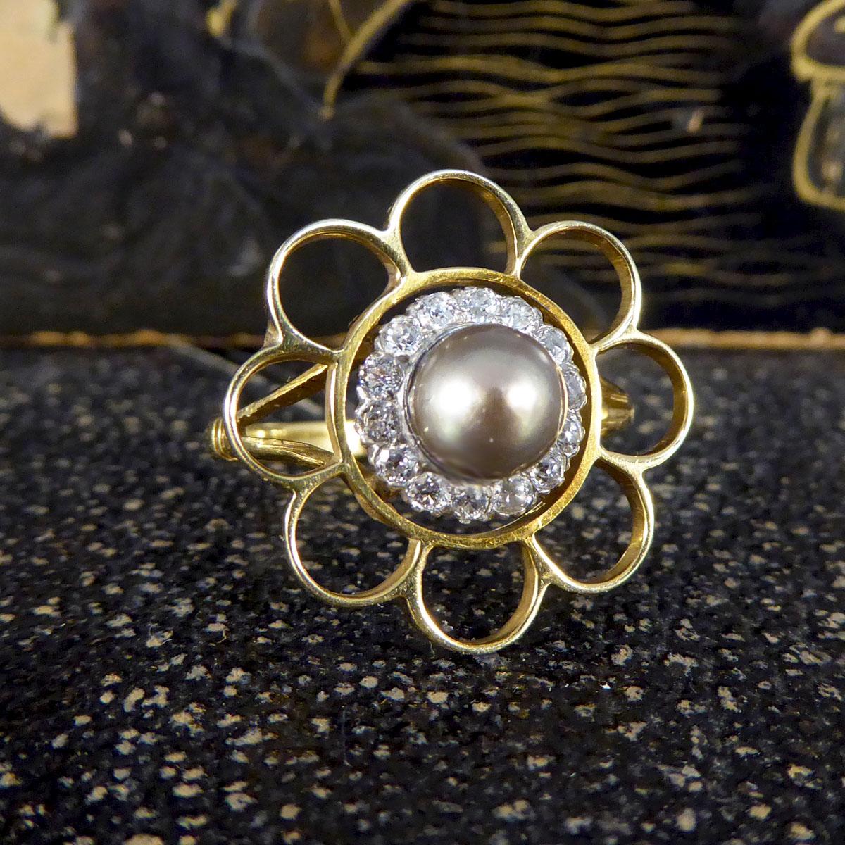 This ring features a lustrous grey Pearl in the centre with a surround of approx 0.40ct Old European Cut Diamonds from the Edwardian era which looks to have been converted from a pin to a ring. Around the antique cluster sits a flower surround