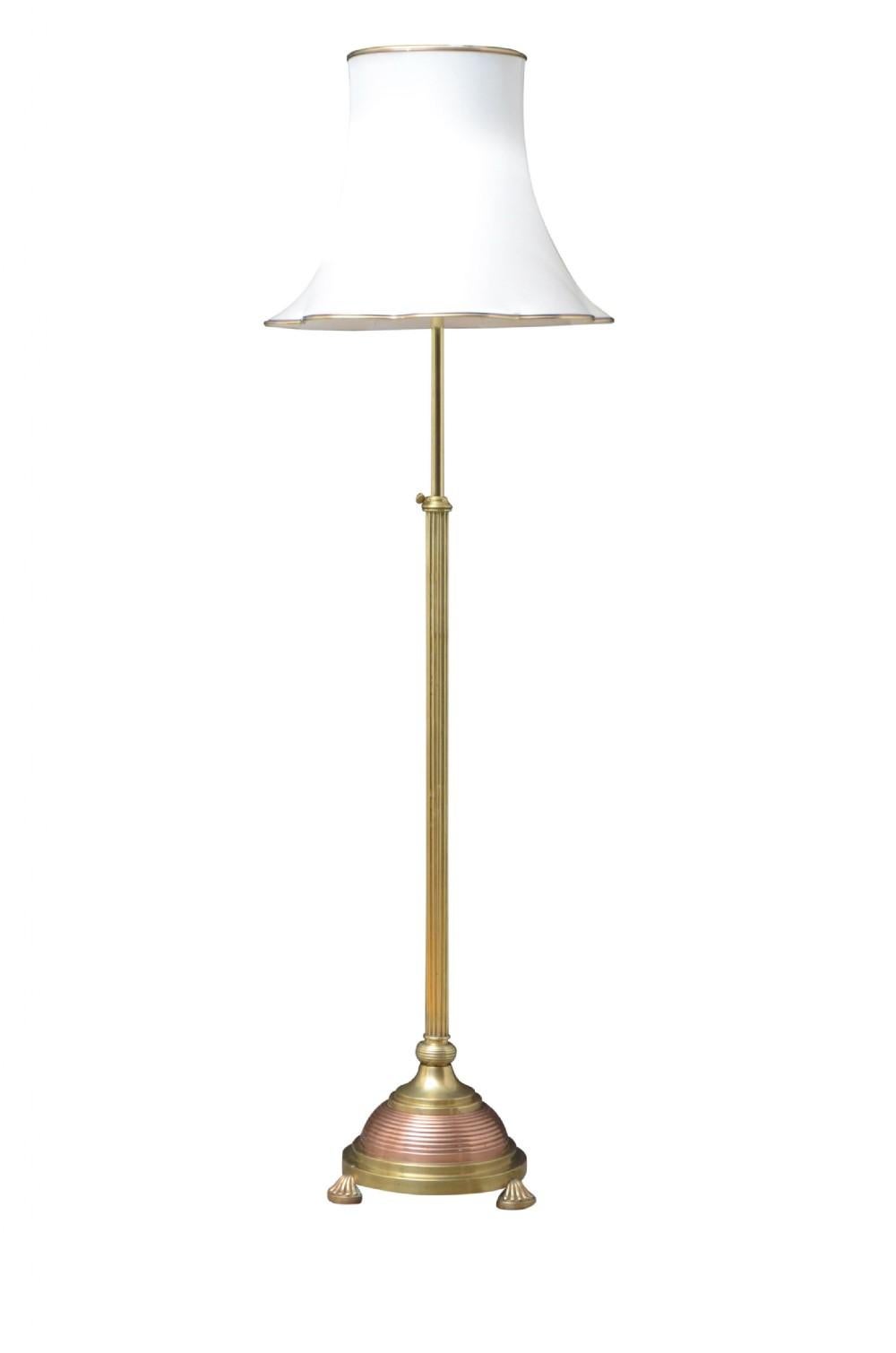 Elegant Edwardian height adjustable standard lamp with brass reeded column terminating in circular copper base and fluted pad feet. This antique lamp has been cleaned and polished, professionally rewired and pat tested, all in home ready condition.