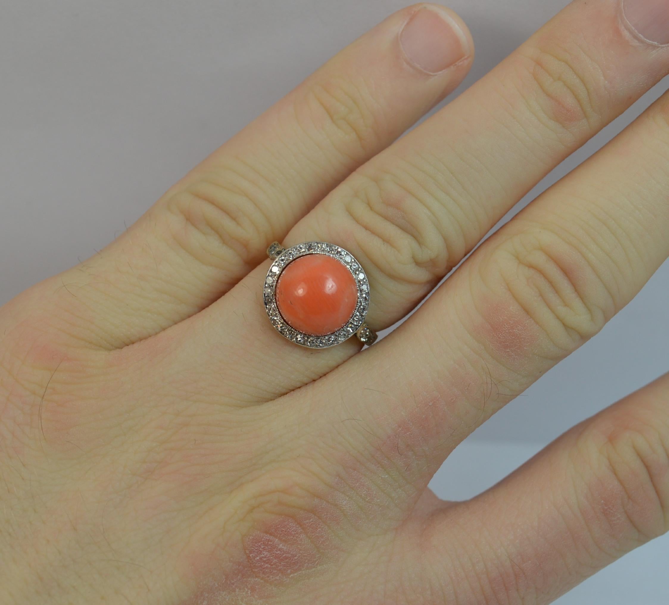 A beautiful late Victorian or Edwardian period ring.
SIZE ; L UK, 5 3/4 US
Solid 18 carat yellow gold shank with platinum setting for the diamonds.

Set with a superb single piece of coral to the centre, 10mm diameter, protruding 8mm.

Surround the