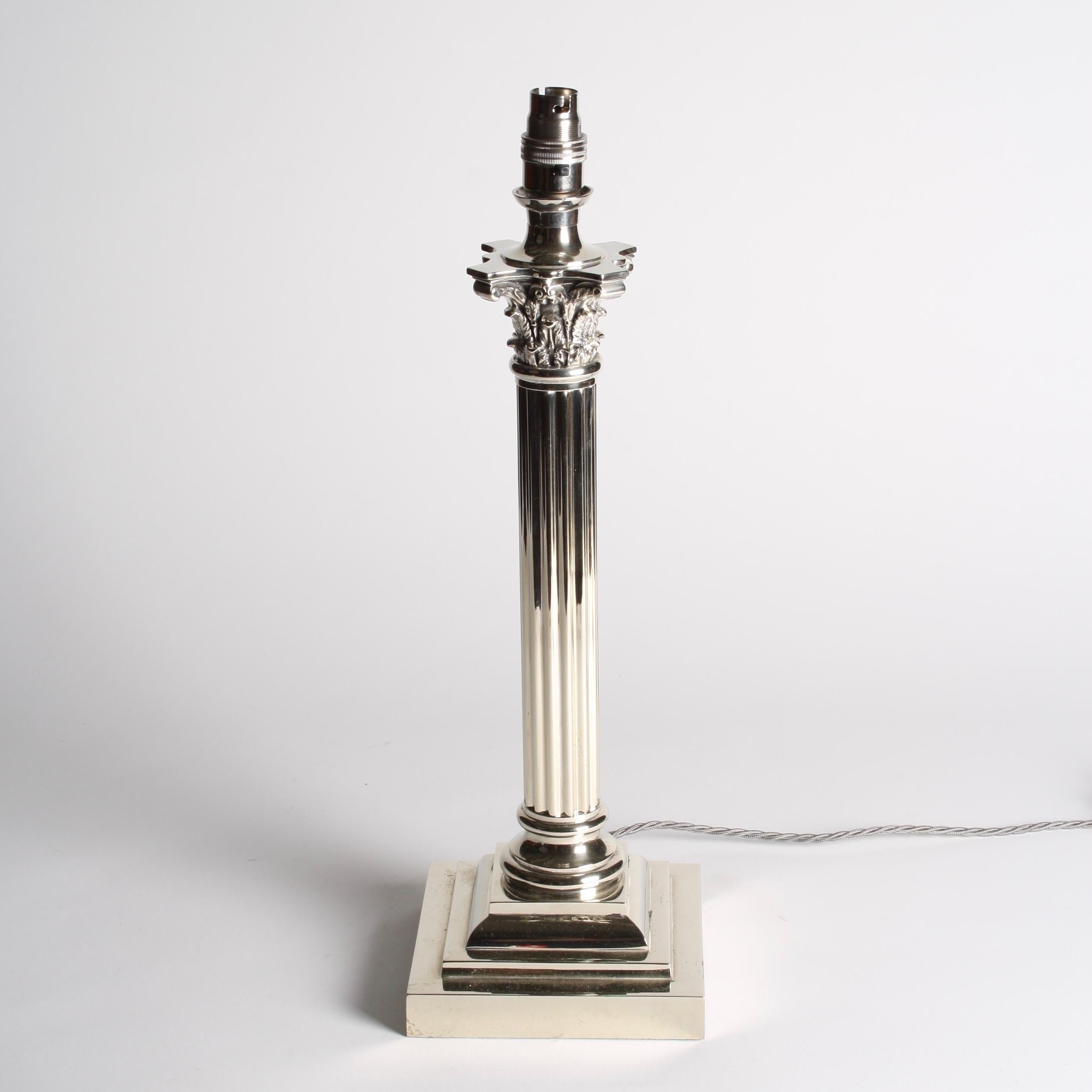 A Corinthian column table lamp with iron weighted base, stepped base marked G. S.

Rewired with switch and braided cable.
 