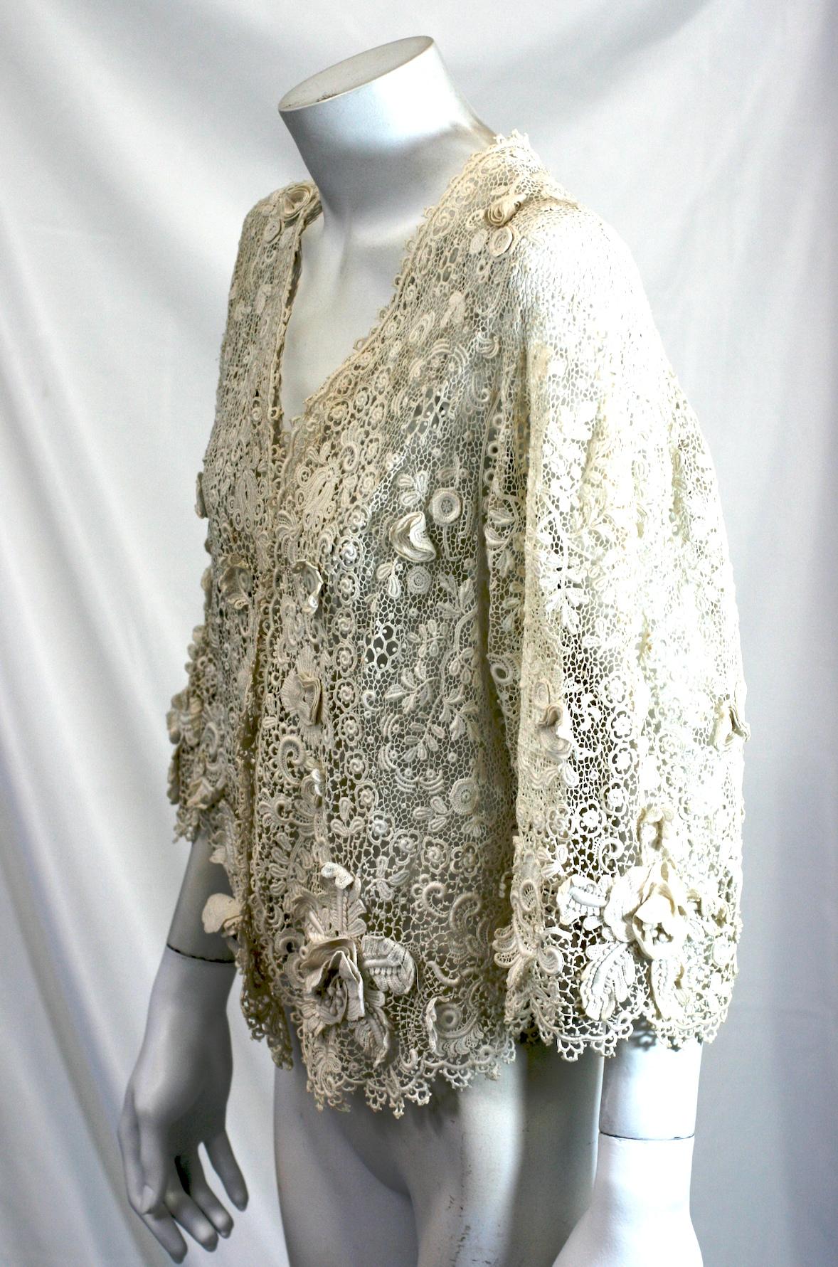 Wonderful Edwardian Crochet Lace Bolero Jacket with huge 3 dimensional florals throughout including large Orchid blooms along the hem and sleeves. The flowers are so dimensional that each petal and stamen is hand crochet.
Extraordinary workmanship