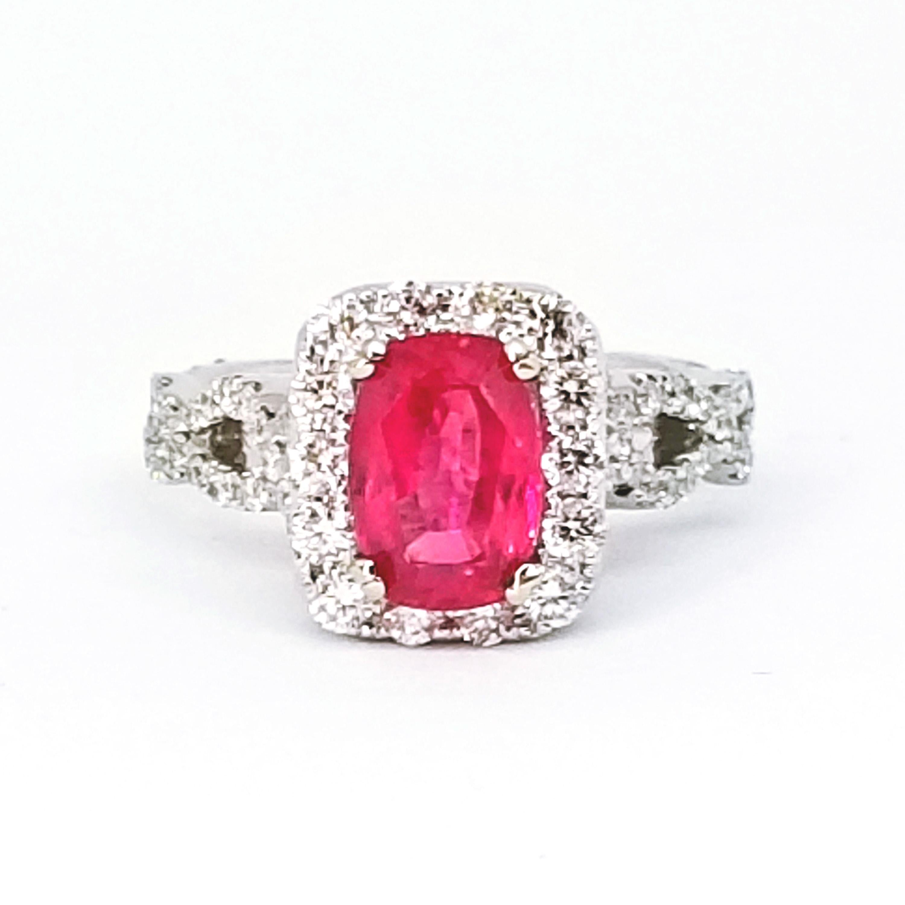 A Contemporary Engagement or Cocktail Ring is set with a 2.19 Carat Edwardian Cut Intense Pink Sapphire with Deep Color Saturation. The Gem ranges in Color from Deep Pink to Pink Red and is surrounded by a Halo of Round Brilliant Diamonds. The Woven