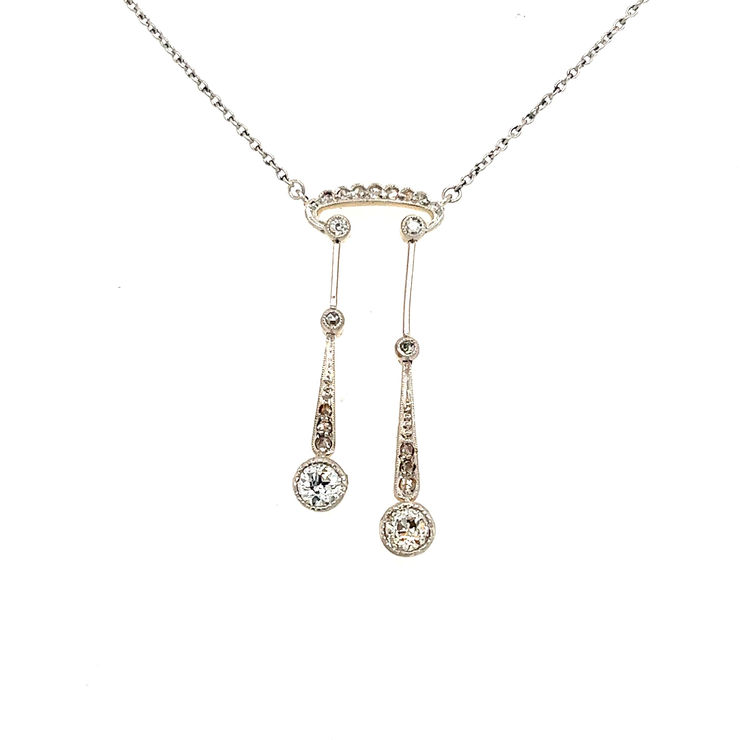 Beautiful design crafted in 18k white & yellow gold. The necklace shows a delicate design that has tons of Edwardian appeal. The necklace is set with rose cut & old mine cut diamonds. The necklace is highlighted with two golden bars that connect to