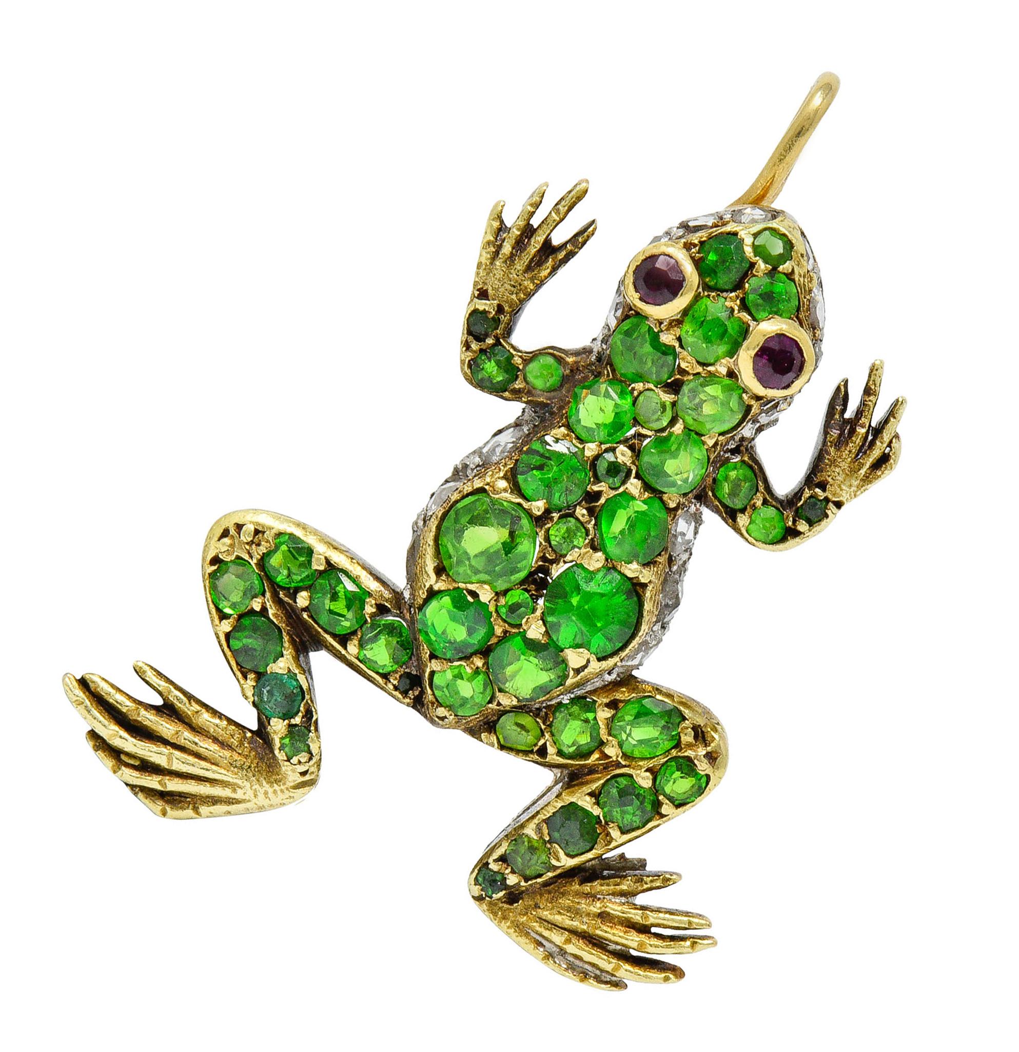 Designed as a frog with yellow gold back and limbs that contrasts platinum at its sides

Pavè set throughout by vibrant lime green demantoid garnets and near colorless rose cut diamonds

Accented by bright red round cut ruby eyes, bezel set

Tested