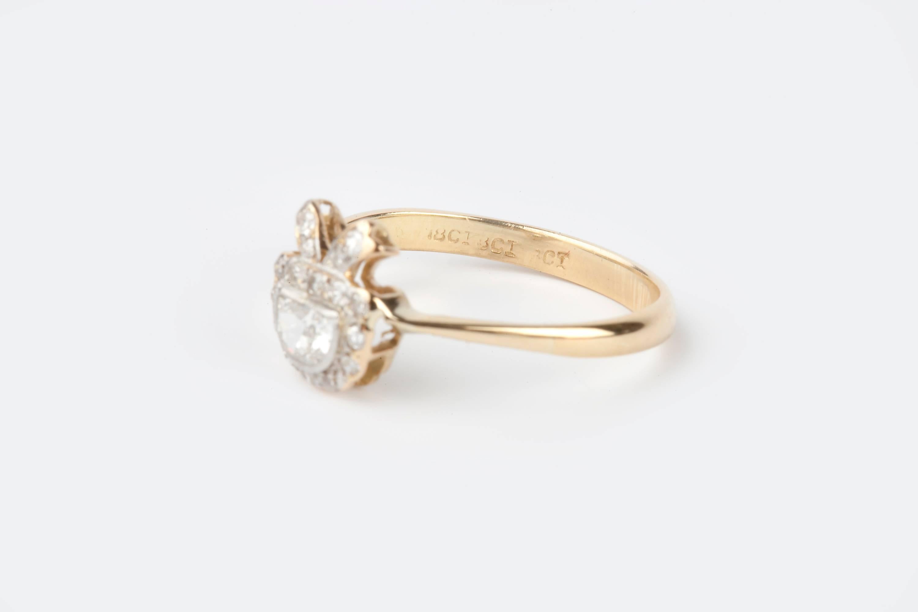 A beautiful present shaped diamond demilune cut Edwardian ring, 18k gold and Platinum set.  The ring is shaped like a gift or present to the wearer.  The ring is unusual and the diamond is VS2 quality and J colour. 