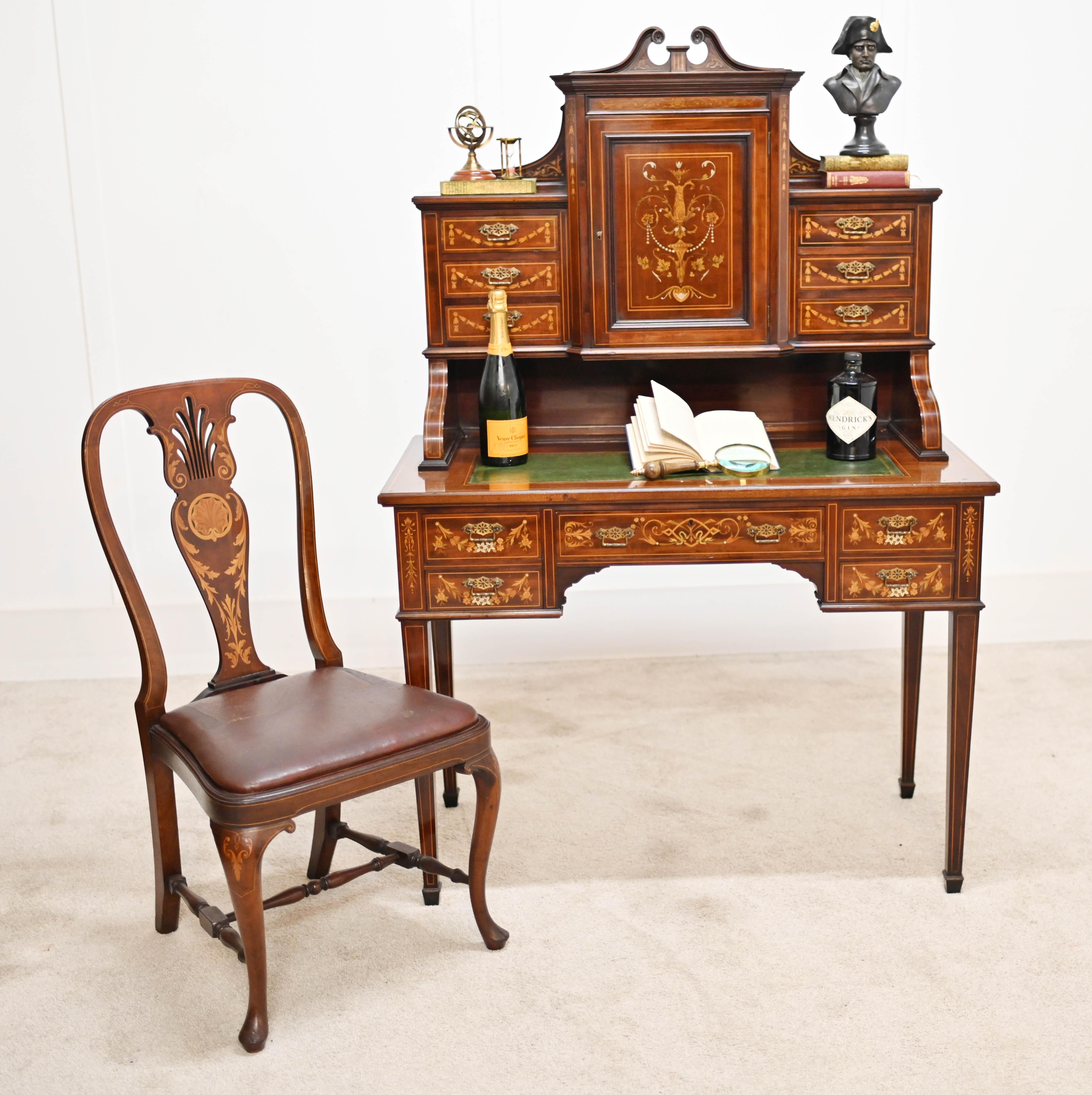 Eye catching Edwardian desk and matching chair set both in mahogany
Circa 1910 and originally made by Maple & Co - please see photo of stamp and makers mark on listing
Extensively inlaid with satinwood boxwood and pearl inlays 
Inlay work on chair