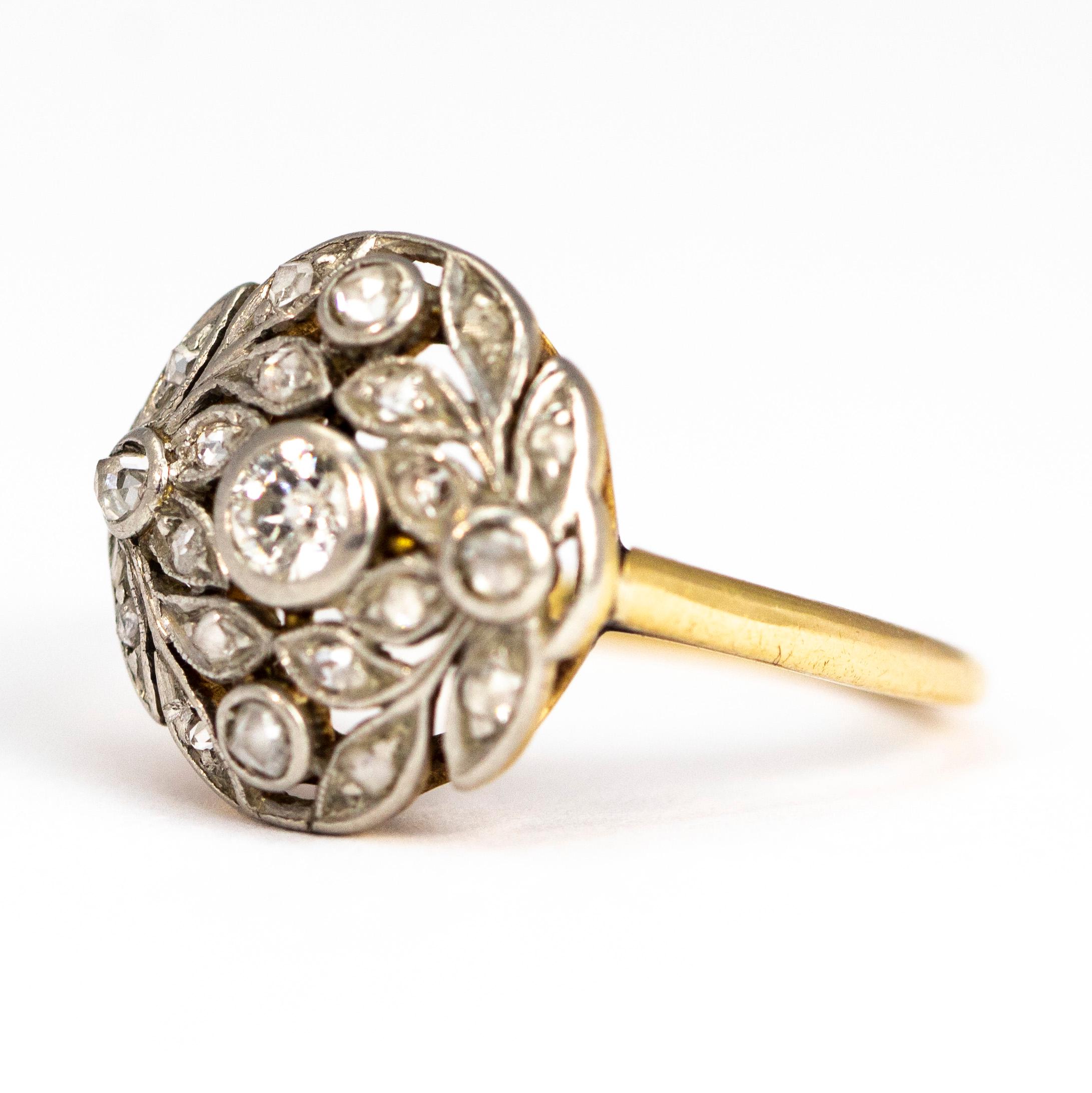 This ornate piece holds gorgeous sparkling diamonds. At the centre there is a 20pt Old Mine Cut diamond and scattered around this in leaf style settings are rose cut diamonds. The ring is modelled in 18ct gold and the stones are set in