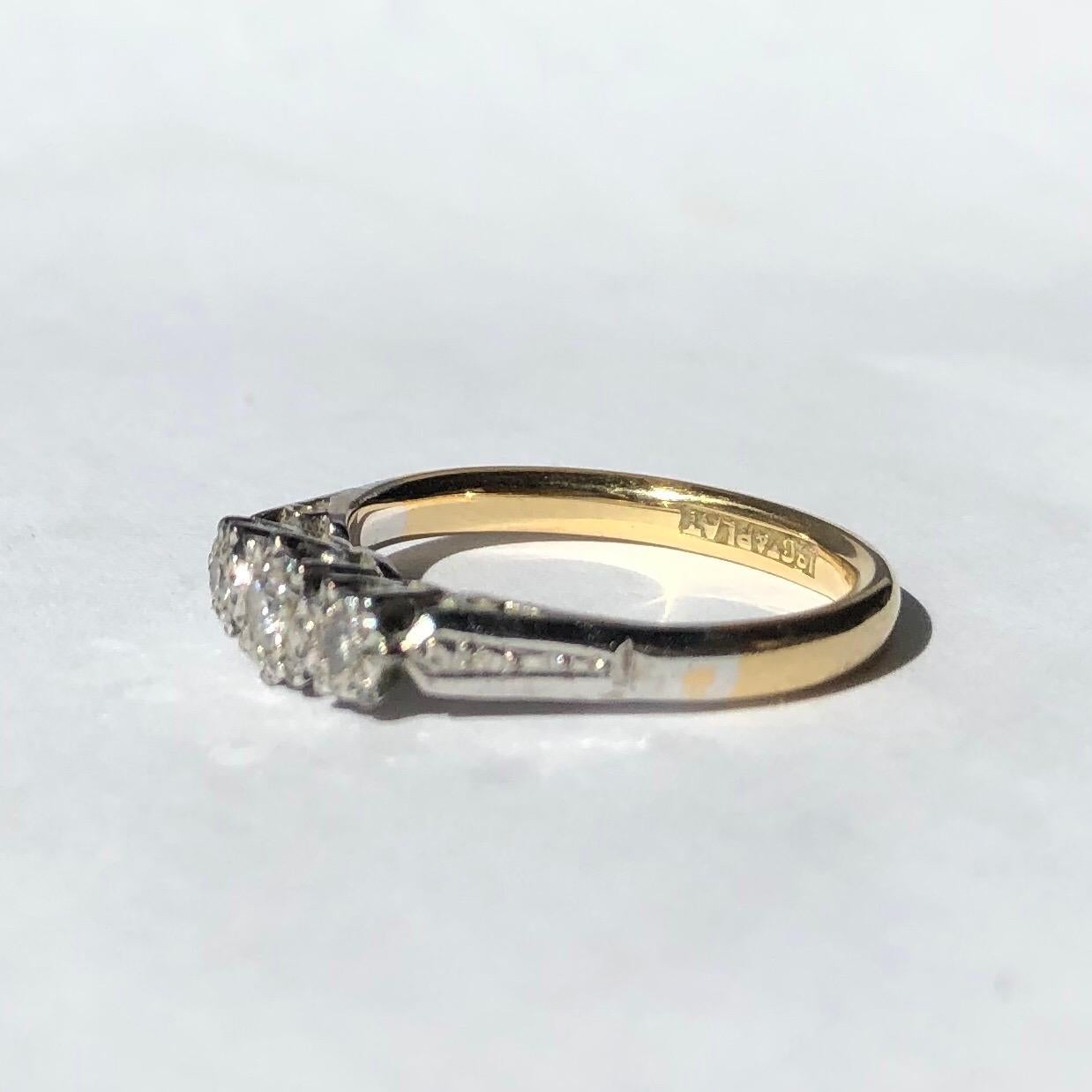 The three stones in this ring are set in illusion settings which make the diamonds appear larger. The diamonds total 20pts. The stones are set in platinum and the rest is made with 18carat gold. 

Ring Size: J 1/2 or 5 
Height Off Finger: