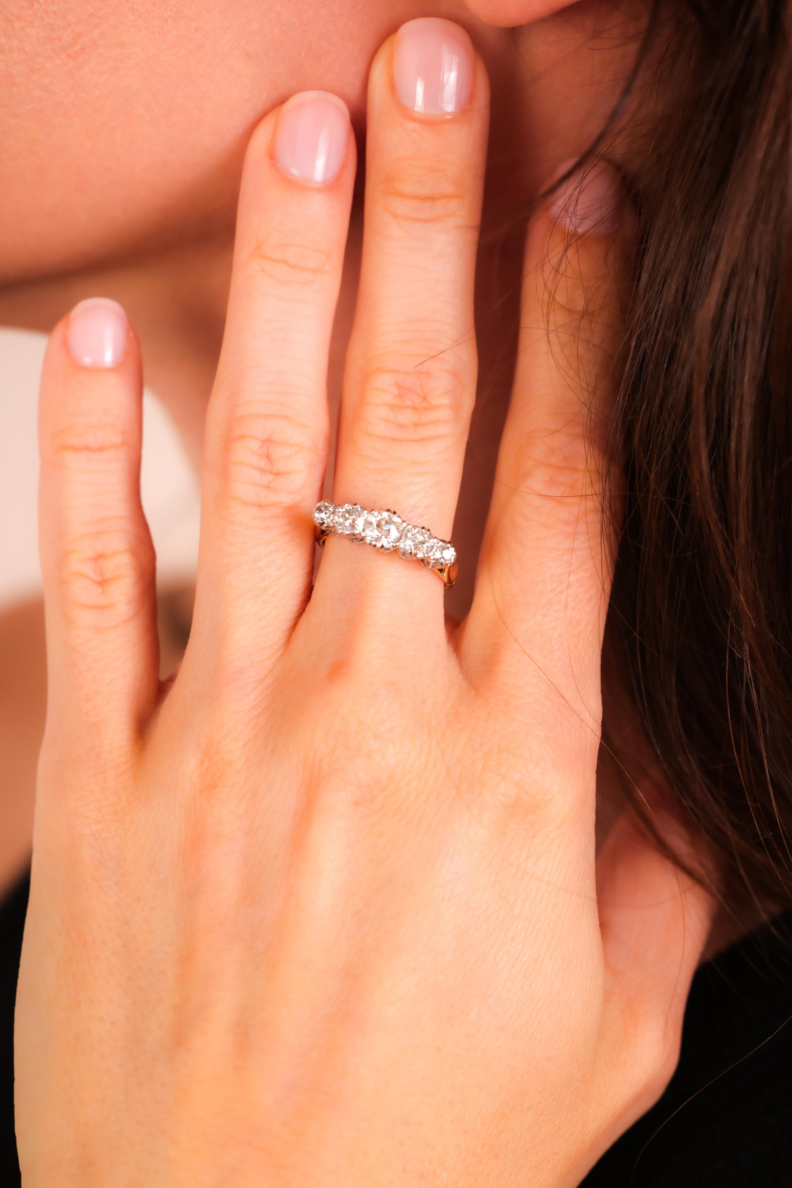 Center Stone: 5 Diamonds
Cut: Round Brilliant
Weight: Approximately 1 Carats
Color: H
Clarity: VS
Metal: 18K Yellow Gold and White Gold
Era: Edwardian
Circa: 1910s
Hallmarks: 18K Purity Marks
Size: 5.5 and can be resized
Gram weight: 3.66 

This