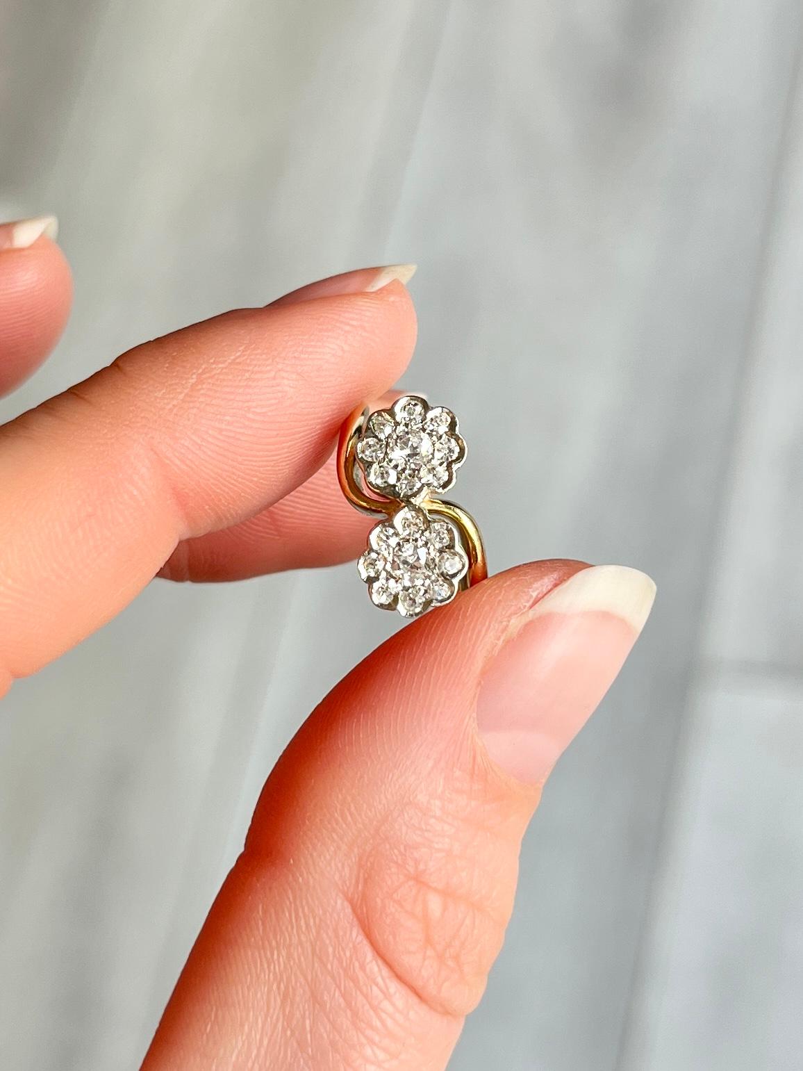 This wonderful double diamond cluster holds sparkling diamonds totalling 34pts per cluster. The clusters are wonderfully twisted and the ring is modelled in 18ct gold and the stones set in platinum. 

Ring Size: H 1/2 or 4 
Widest Point: 12mm