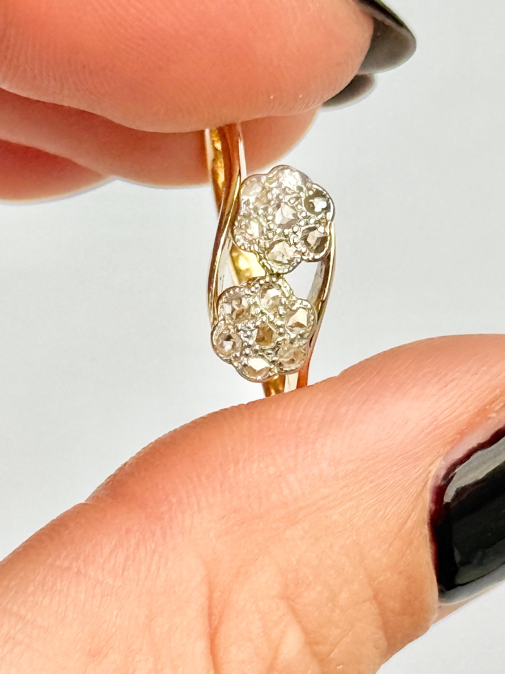 This wonderful double diamond cluster holds sparkling diamonds measuring 2pts each at the centre and around the centre stone the diamonds measure 2pts. The clusters are wonderfully twisted and the ring is modelled in 18ct gold and the stones set in