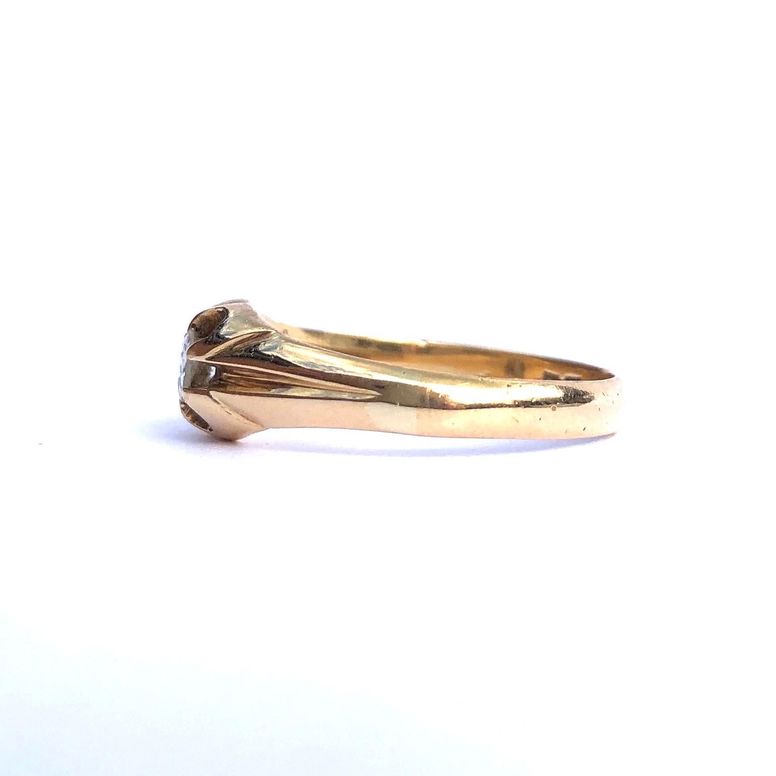 Set on this decorative setting within this glossy 18ct gold band is a 20pt diamond. The diamond is bright and very sparkly and is old European cut. Made in London, England. 

Ring Size: Q or 8 1/4
Band Width: 6mm

Weight: 3.36g