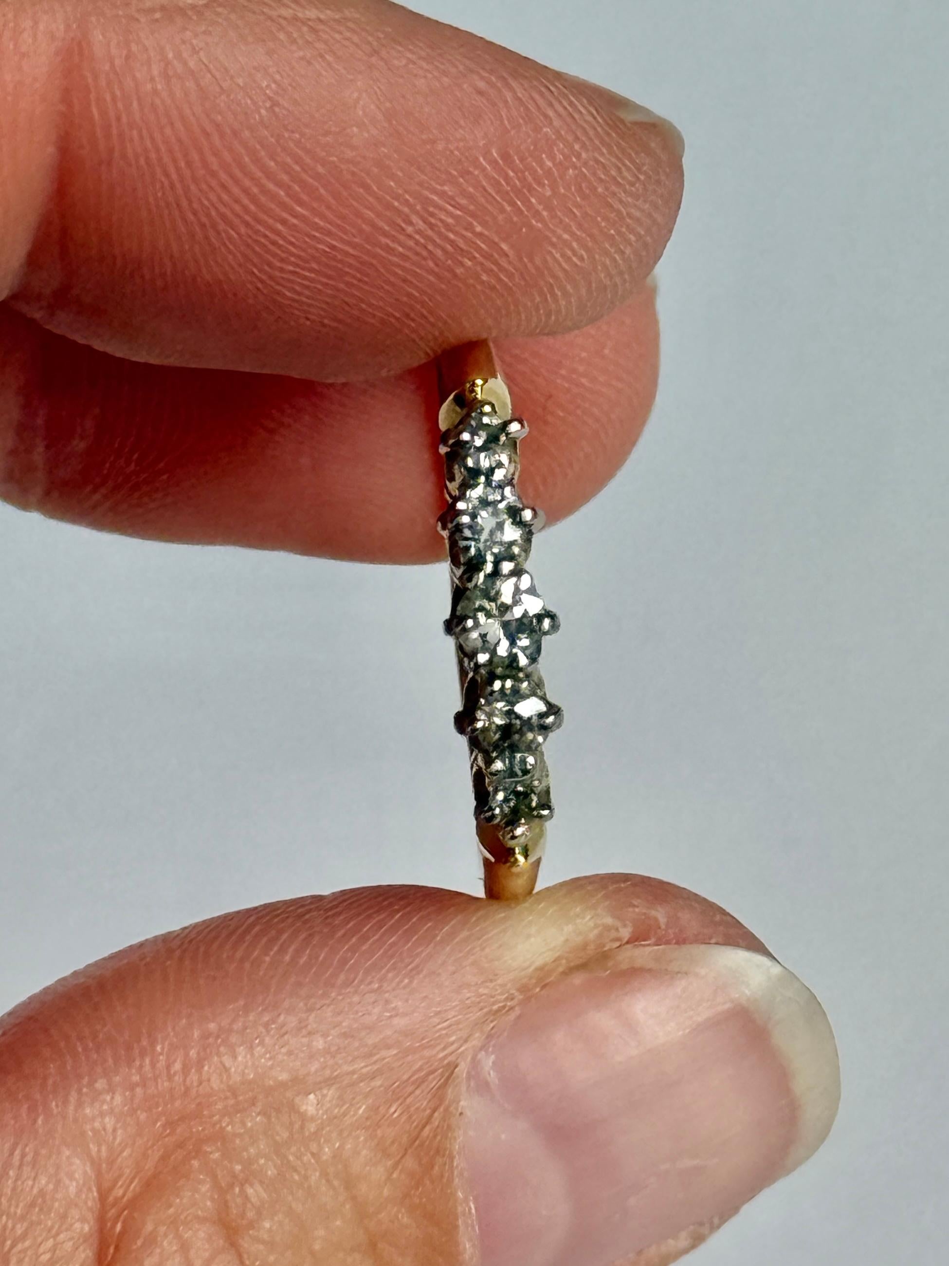 Set in this 18carat gold ring are five diamonds. The central diamond measures 7pts and the smallest diamonds measure 3pts each. Diamond total of this ring is 21pts. 

Ring Size: Q 1/2 or 8 1/2
Face Width: 4mm 
Height Off Finger: 4mm

Weight: 2.2g