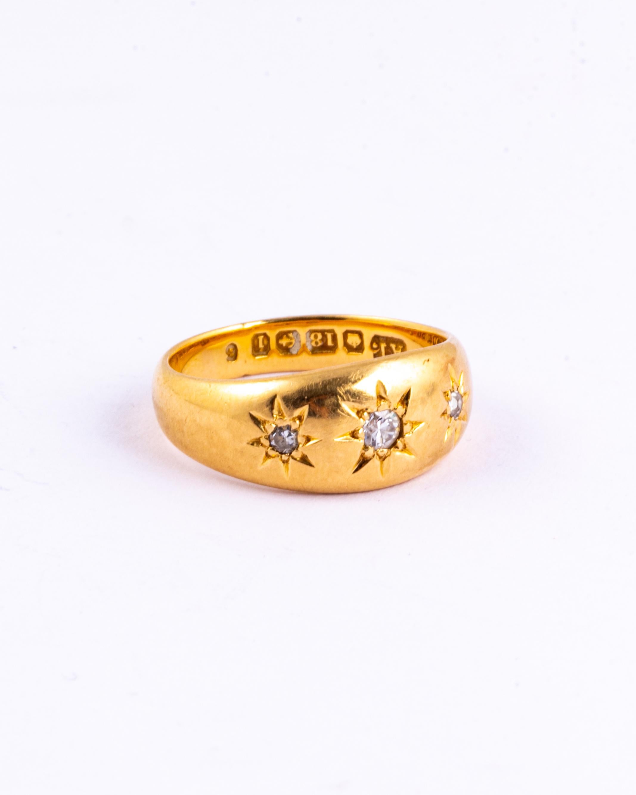This gypsy ring holds three diamonds totalling approx 20pts and these are set in star settings. The glossy gold band is modelled in 18ct gold and made in Birmingham, England.

Ring Size: K or 5 1/4 
Band Width: 8mm

Weight: 6.2g