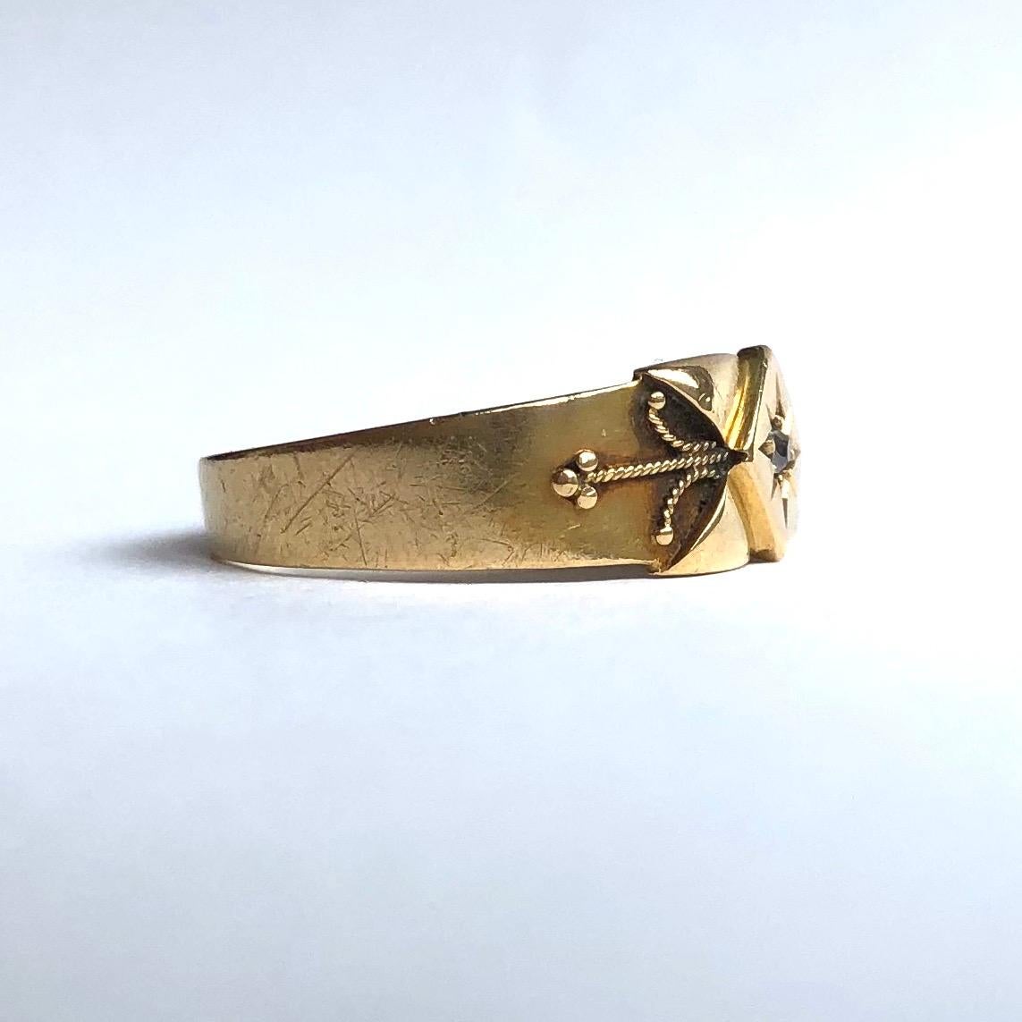 The style of this band is so lovely! At the centre, in a slightly raised diamond shape, is a small yet sparkly 4pt diamond. Off this diamond shape are four triangles making the detail look like a cross and there is very fine twisted gold that comes