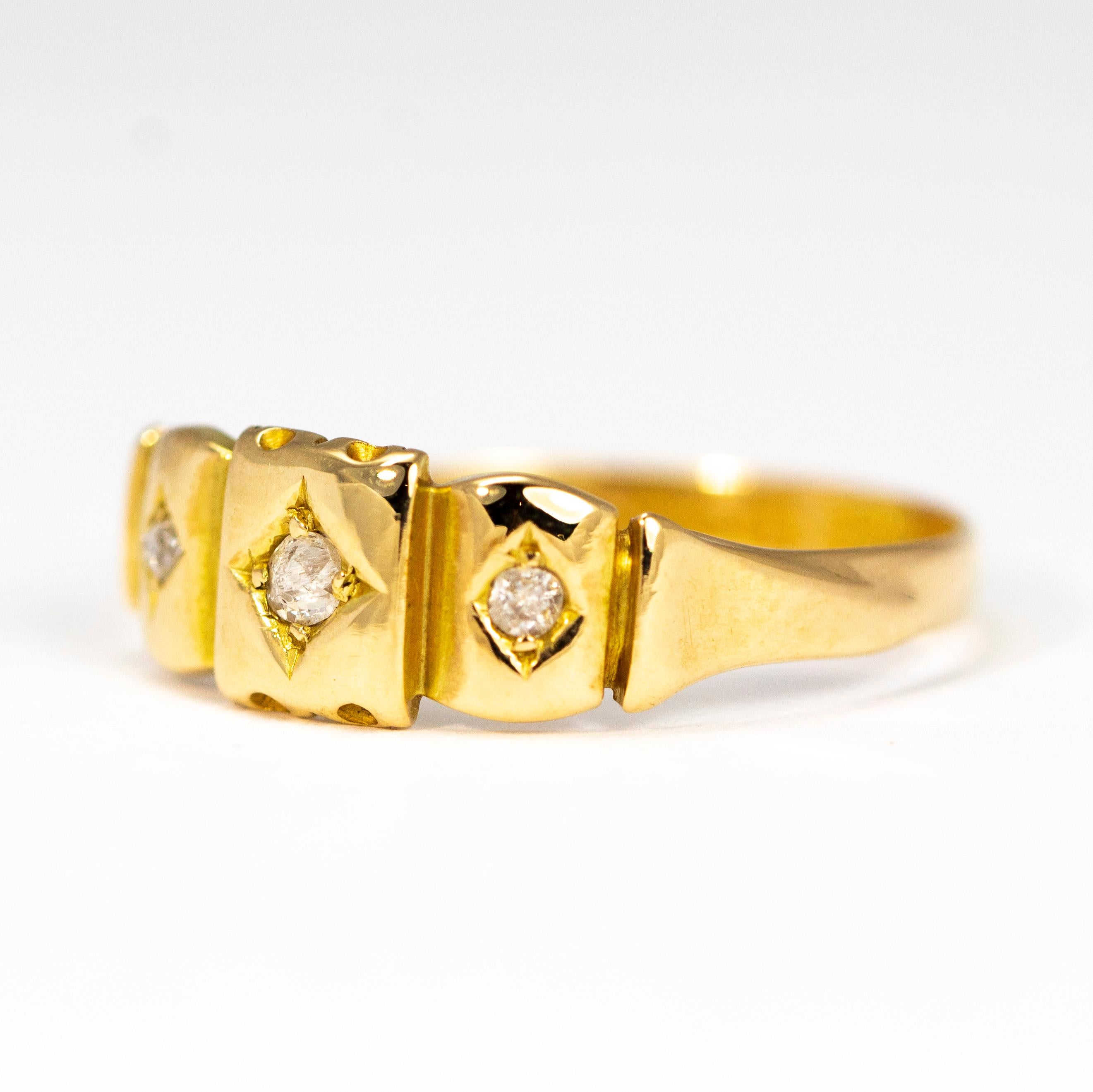 The central diamond in this band measures 6pts and the slightly smaller outer stones measure 4pts each. The stones are set in separate decorative panels of gold in diamond shaped settings. Made in Chester, England. 

Ring Size: O 1/2 or 8 1/4
Band