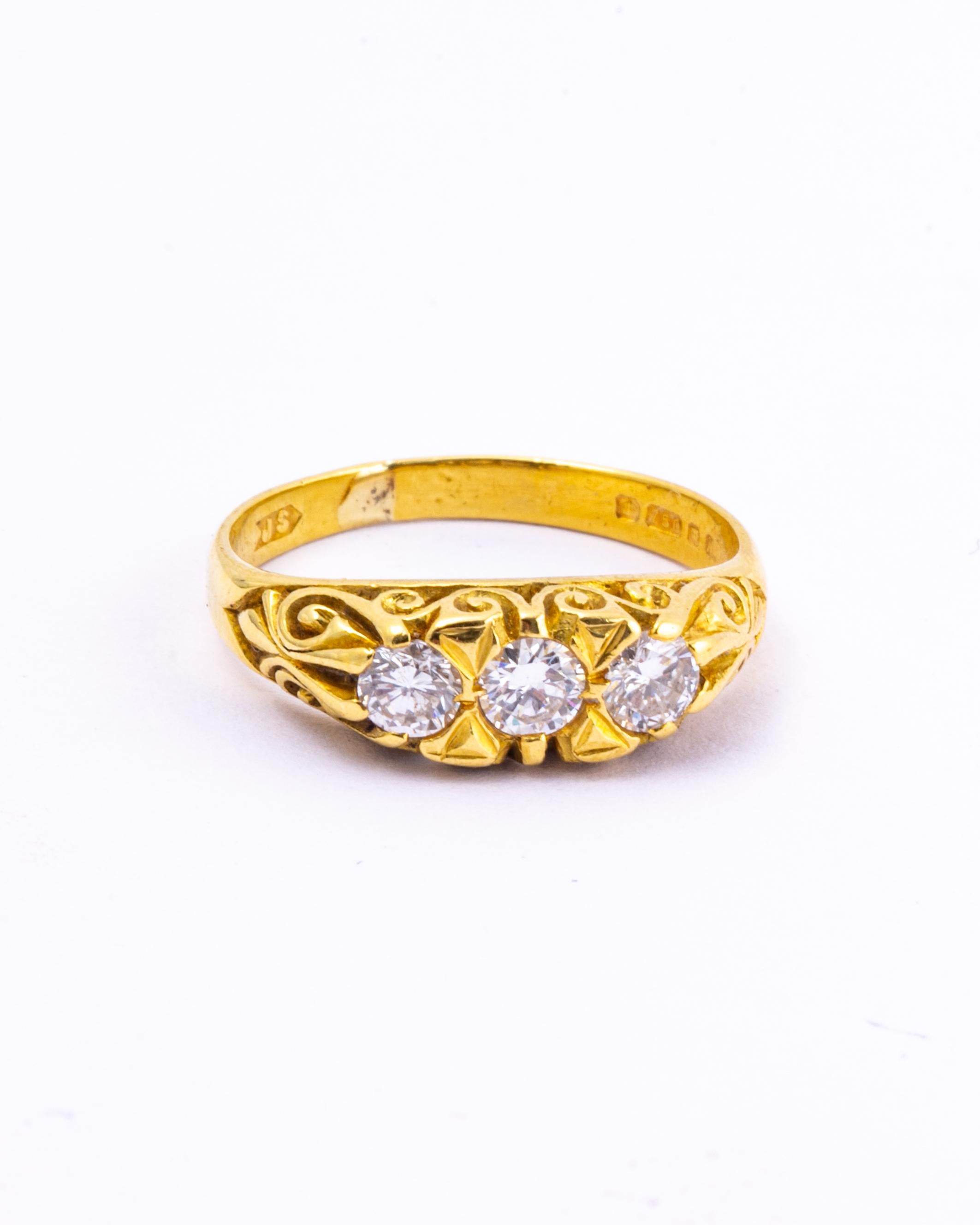 The design of this ring is a timeless classic. The three diamonds total approx 50pts and are all set within the ornate setting. The diamonds are bright and wonderfully sparkly and the ring is modelled in 18ct gold.  

Ring Size: L 1/2 or 6 
Widest