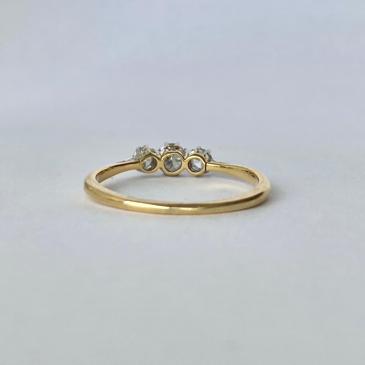 The diamonds in this ring total 60pts and old European cut and are bright and sparkly. They are held in very subtle platinum calaws upon an 18carat gold band. 

Ring Size: Q or 8 

Weight: 2g