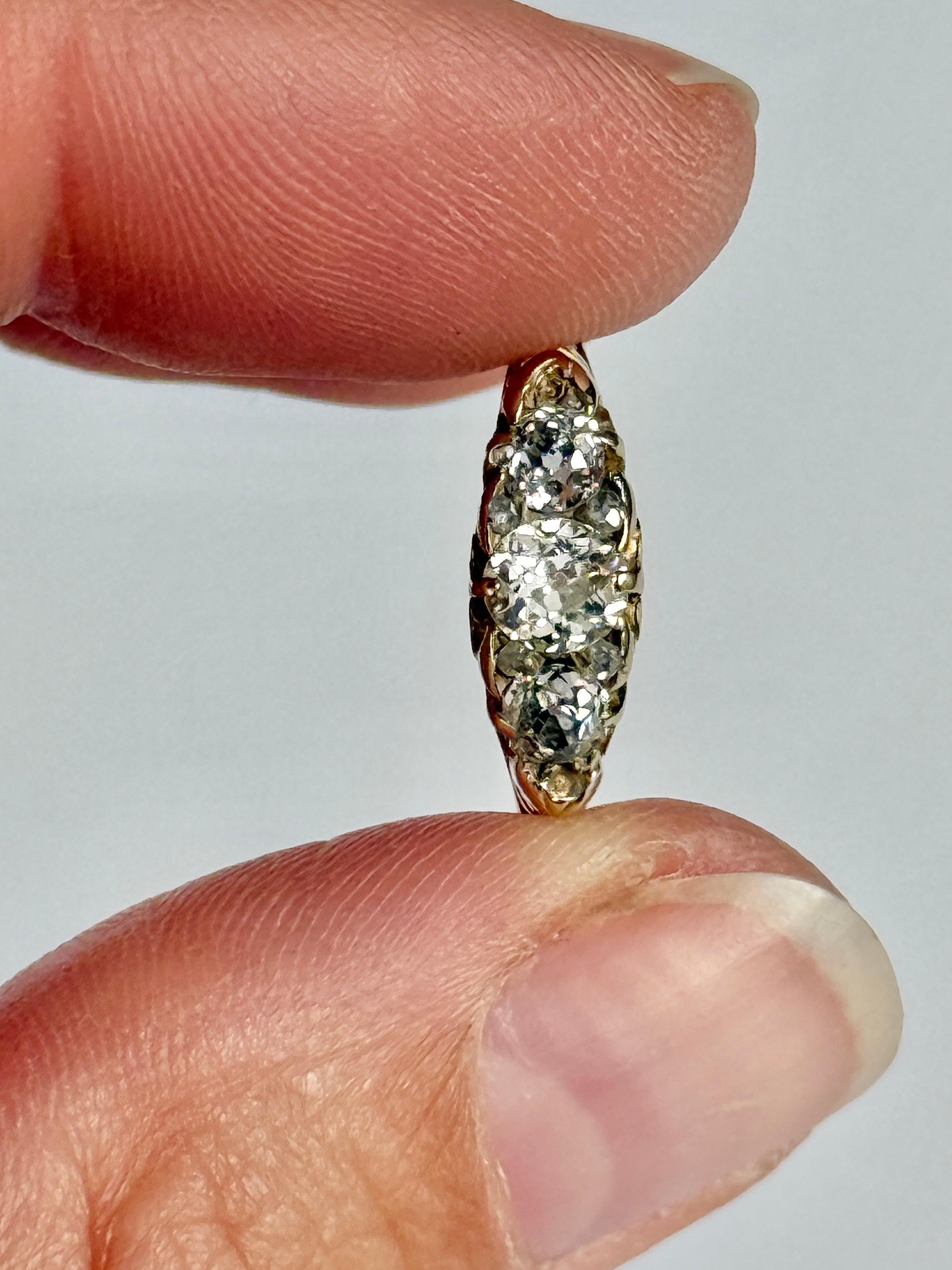 This sparkling Edwardian diamond three stone holds three diamonds totalling 70pts and modelled in 18 carat yellow gold. in between the larger diamonds are smaller rose cut diamond points.  

Ring Size: Q or 8 1/4
Height Off Finger: 4mm

Weight: 2.8g