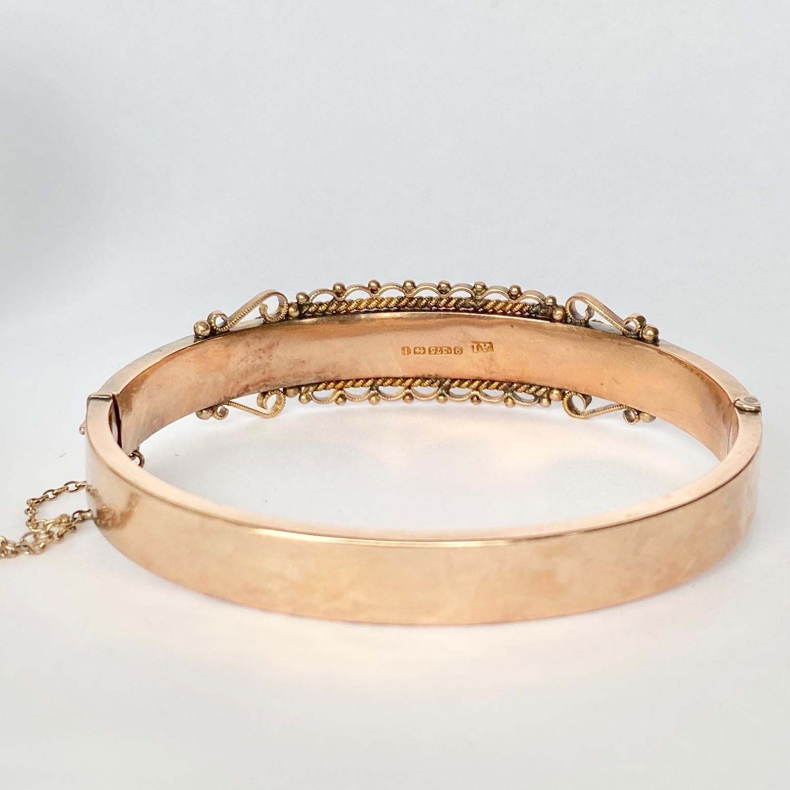 The 9 carat gold is bright and the bangle has so much detail. The bangle has a panel on the front holding three diamonds and has plenty of detail as you can see in the images. The diamonds total 20pts. Fully hallmarked Birmingham 1908.

Inner