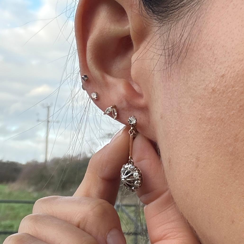 These sparkly old mine cut diamond cluster earrings hold a total of approximately 65pts each. The earrings are modelled in 9ct gold. Comes in original box.

Cluster Diameter: 11mm 
Drop from Ear: 27mm

Weight: 3.8g
