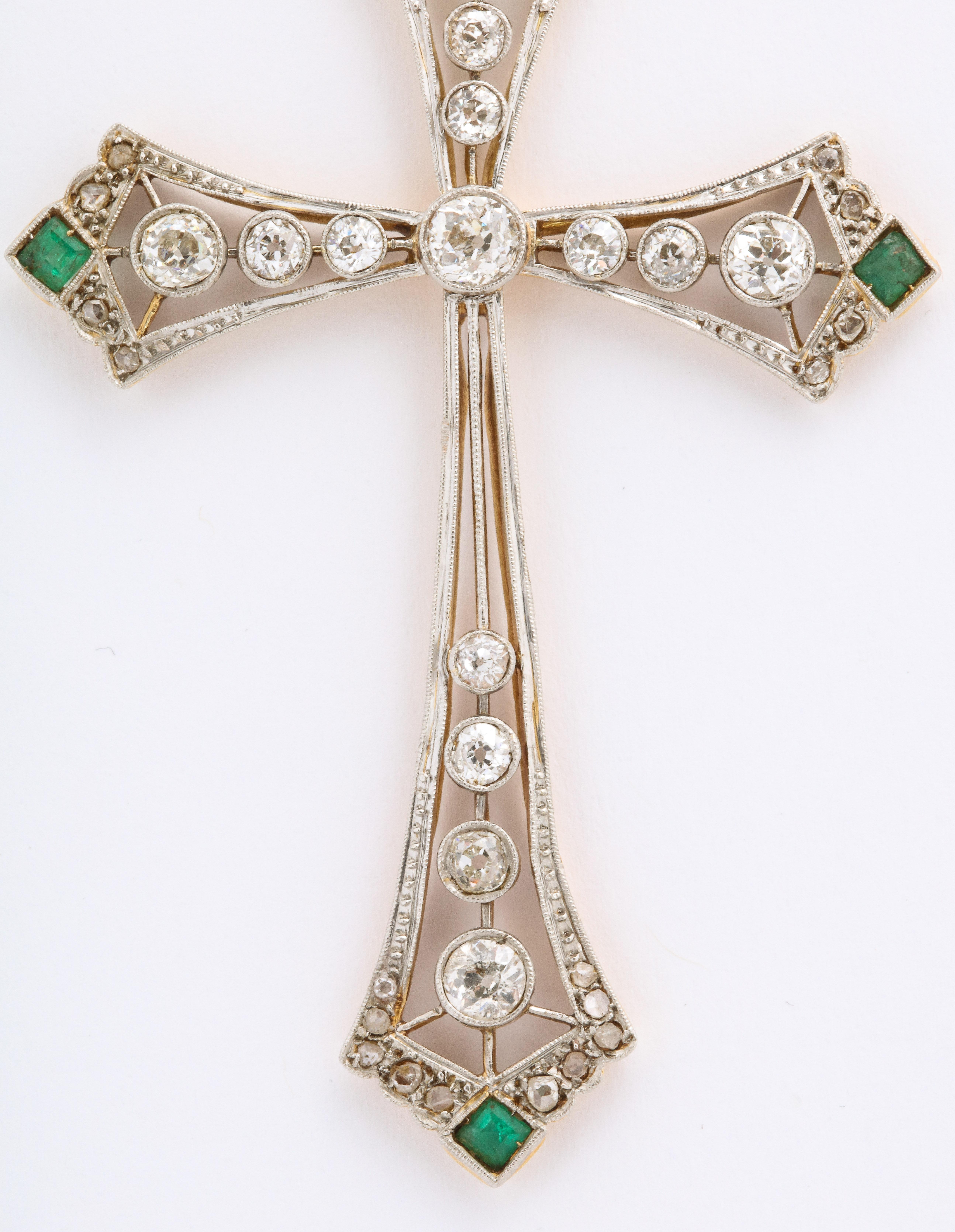 Large Edwardian Diamond and Emerald Cross with openwork is handmade in two colors of 14k gold embellished with 2 ctsof old European and rose cut diamonds accented by emeralds