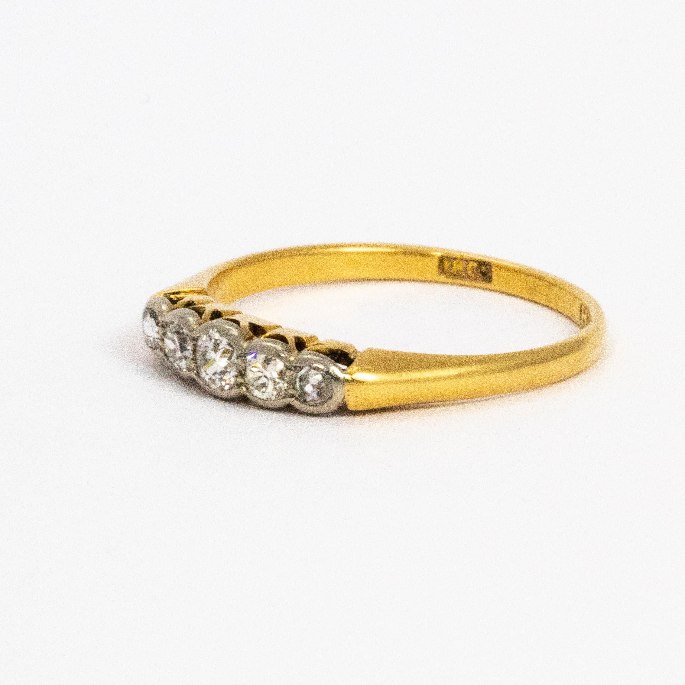 A delicate 18 karat gold band with 5 shimmering diamonds set in platinum.

Ring Size: M 1/2 or 6 1/2 