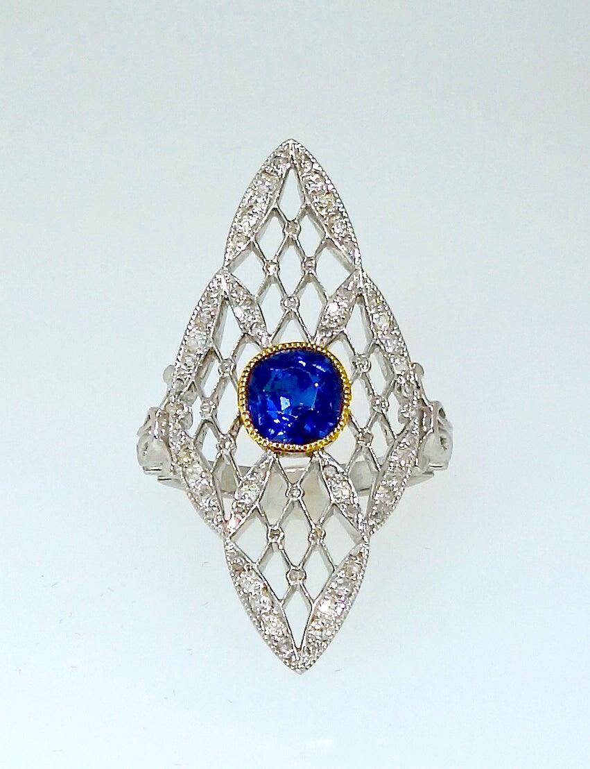 Edwardian jewelry at its best!  The platinum lattice work is set with tiny white fine diamonds which centers a fine blue natural, no heat or treatment,  sapphire is probably Burma. This sapphire weighs approximately 1 ct.  This ring, in fine