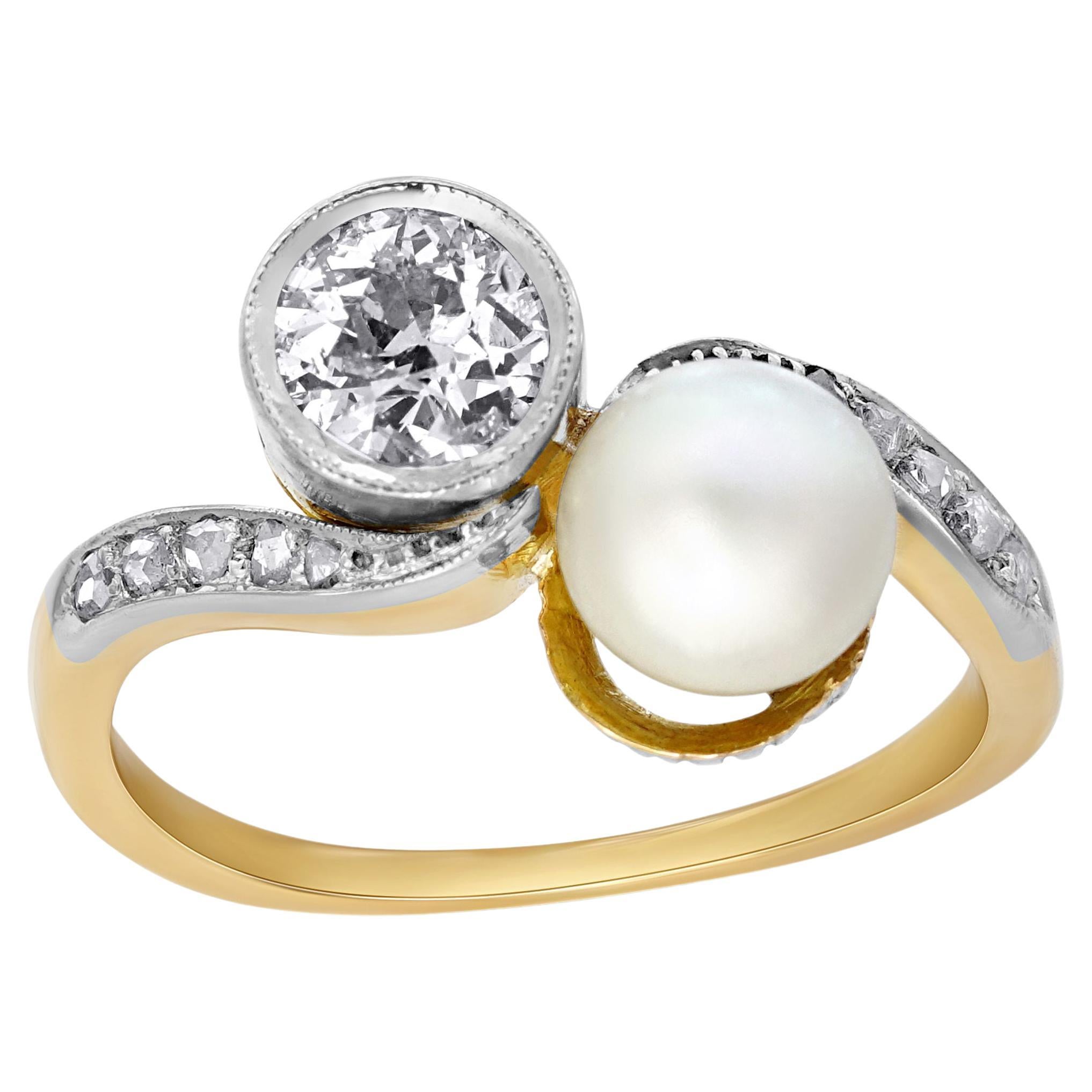 Simply Beautiful! Finely crafted Edwardian Diamond and Pearl 'Toi et Moi' Bypass 14k Gold Ring. Securely Hand set in Silver with an Old European-cut Diamond, weighing approx. 0.15 Carat and a 6mm Pearl; accented by Diamonds on either side of shank.
