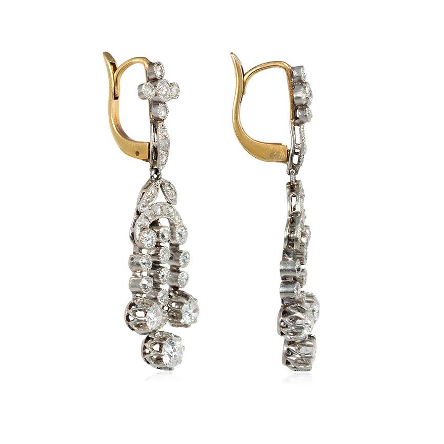 A pair of Edwardian collet-set diamond earrings of girandole design with foliate surmounts, in platinum.  Atw 2.00 ct. full cut and rose cut diamonds.