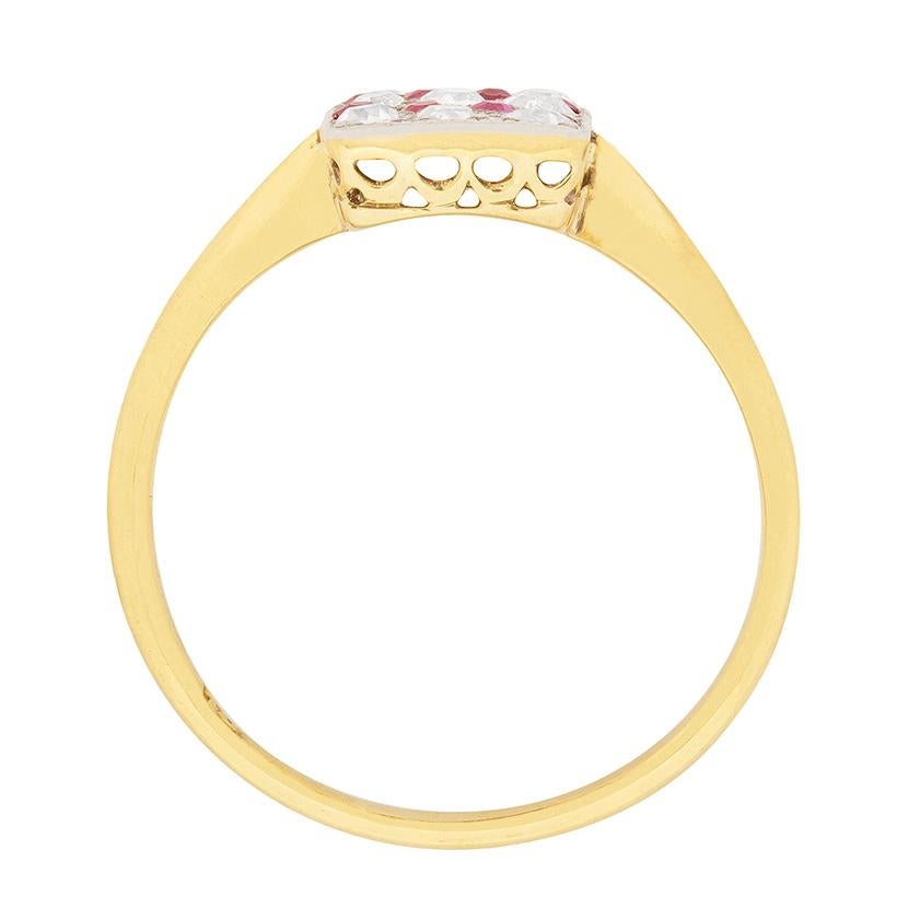 This Edwardian cluster ring features a sparkling set of diamonds and rubies. The diamonds, which are old cuts, have a combined weight of 0.45 carat and are estimated as G in colour and VS2 in clarity. The rubies, which are also old cuts, have a