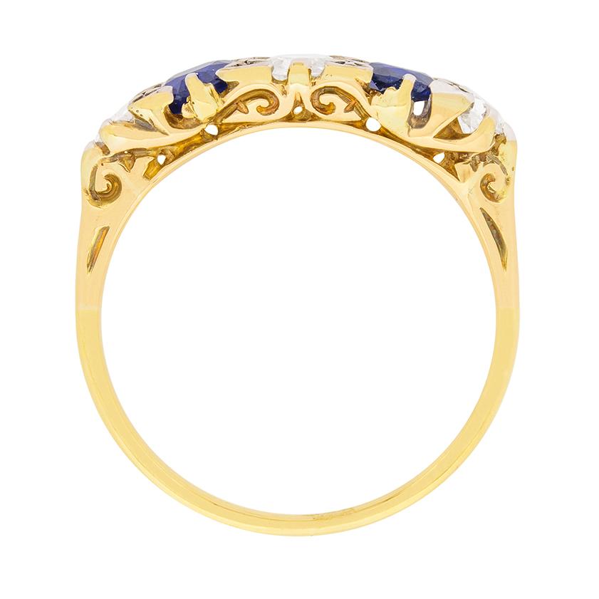 Dating to the Edwardian era, this beautiful five stone ring features old cut diamonds and natural sapphires. The centre diamond weighs 0.40 carat and adjacent are blue sapphires; each weighing 0.35 carat. On the end are two diamonds each weighing
