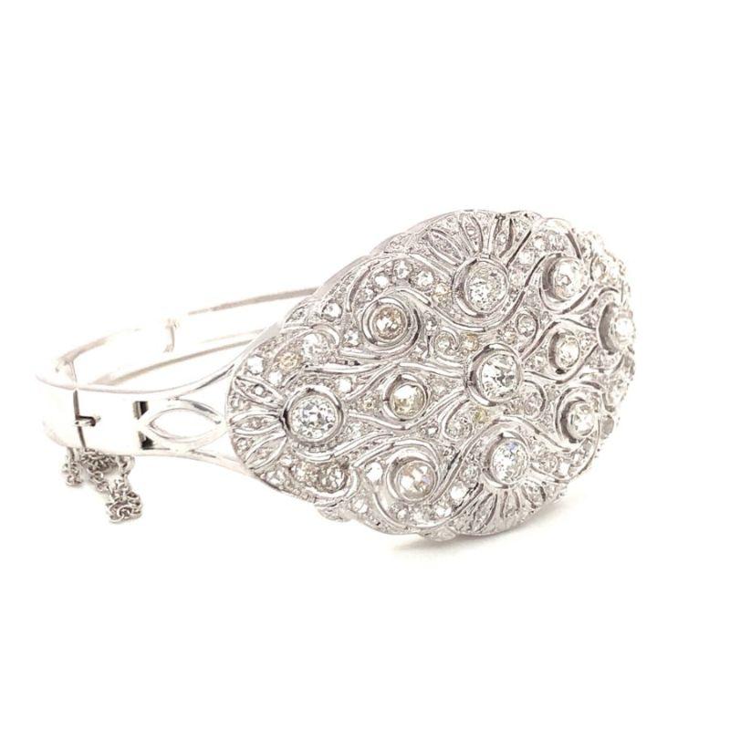 Edwardian diamond hinged bangle bracelet in platinum-topped 14K white gold with hand-pierced filigree design. Totaling 5.50 ct. of old European cut and rose cut diamonds with J-K color and SI-1 clarity.

Gorgeous, perfect, shimmering.

Additional