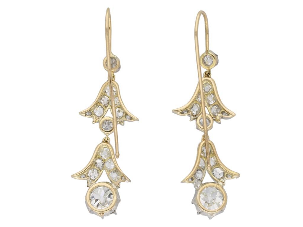 Edwardian diamond drop earrings. A matching pair, each set to bottom with one cushion shape old mine diamond, one J colour, SI2 clarity, with a weight of 1.43 carats, one I colour, SI1 clarity, with a weight of 1.36 carats, in an open back eight