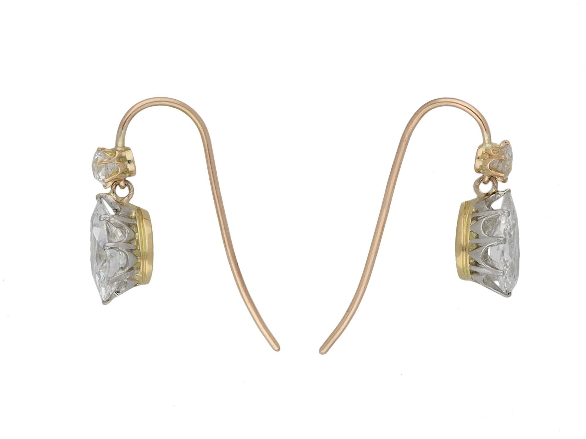 Edwardian diamond drop earrings. A matching pair, each set with one drop shape old mine diamond, two in total, in an open back claw setting with a combined approximate weight of 2.00 carats, suspended from a a round old mine diamond, two in total,