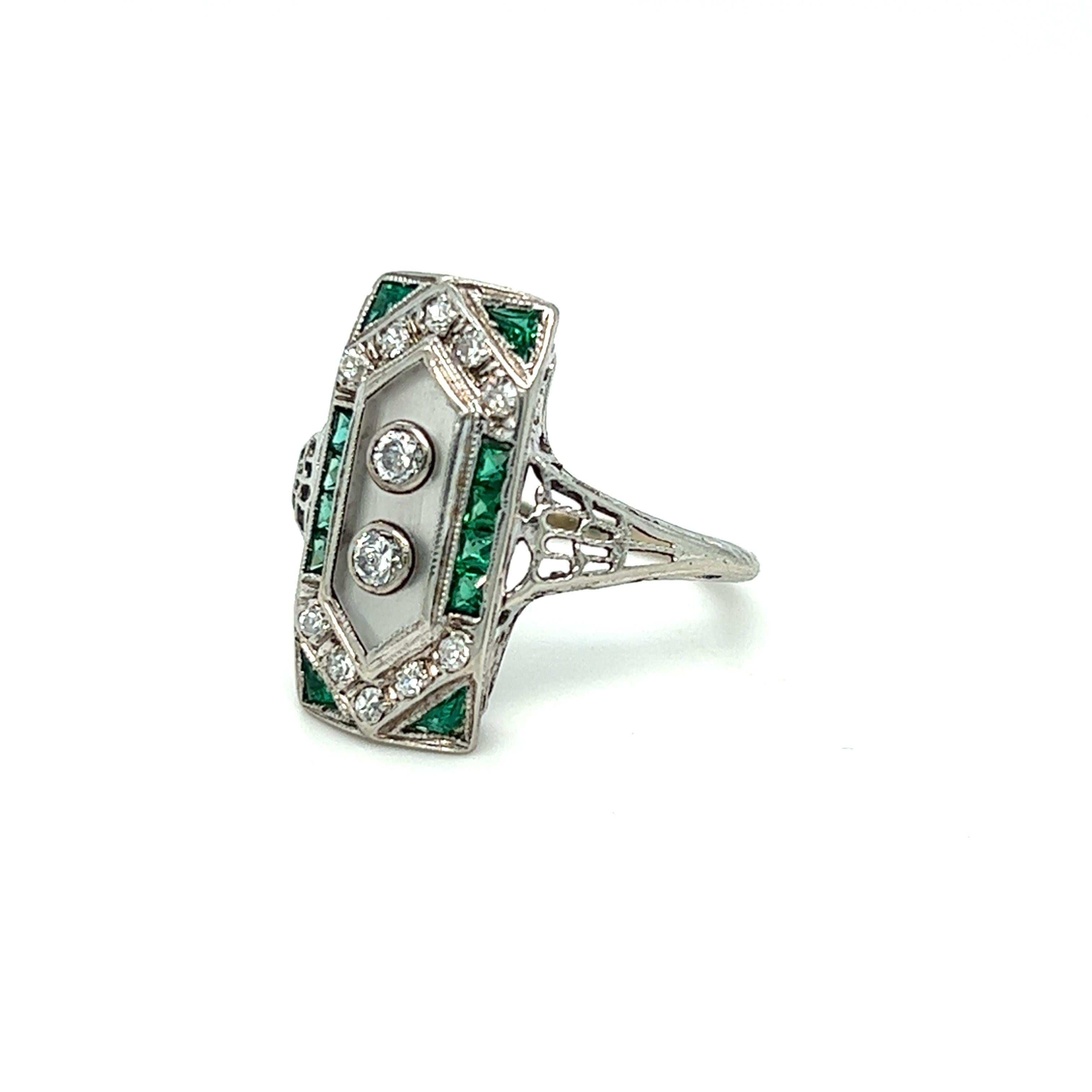 From our antique collection, this beautiful plaque ring contains ten European Cut diamonds weighing approximately 0.40 carat total, eight princess cut and four triangular cut emeralds weighing approximately 0.36 carat total. The two diamonds at