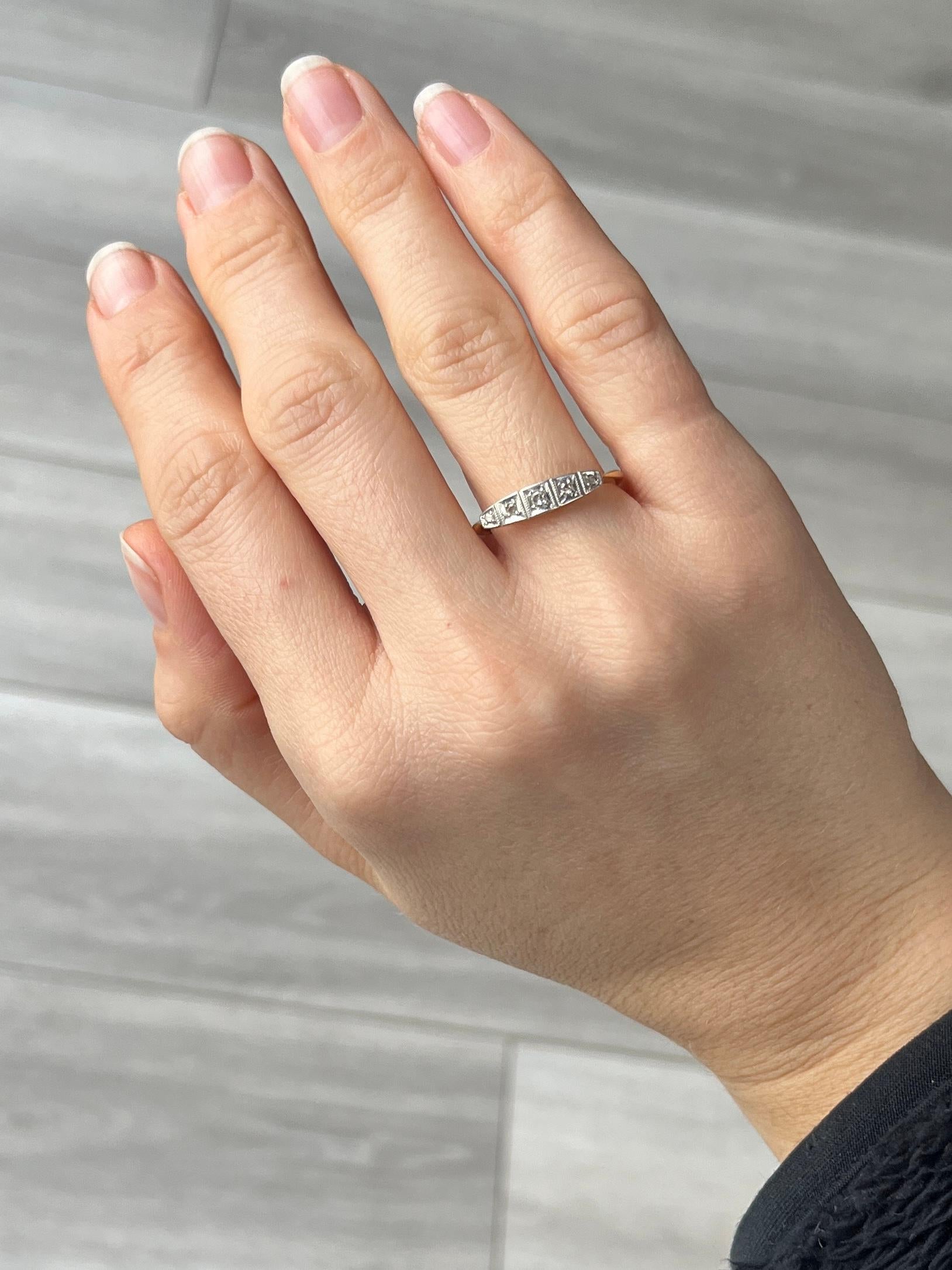 Five glistening diamonds sit fabulously on top of an open work setting modelled in 18ct gold. The central diamond measures 5pts and the smallest diamonds measure 2pts. The stones are all set in platinum. 

Ring Size: N or 6 1/2 
Width: 4mm

Weight: