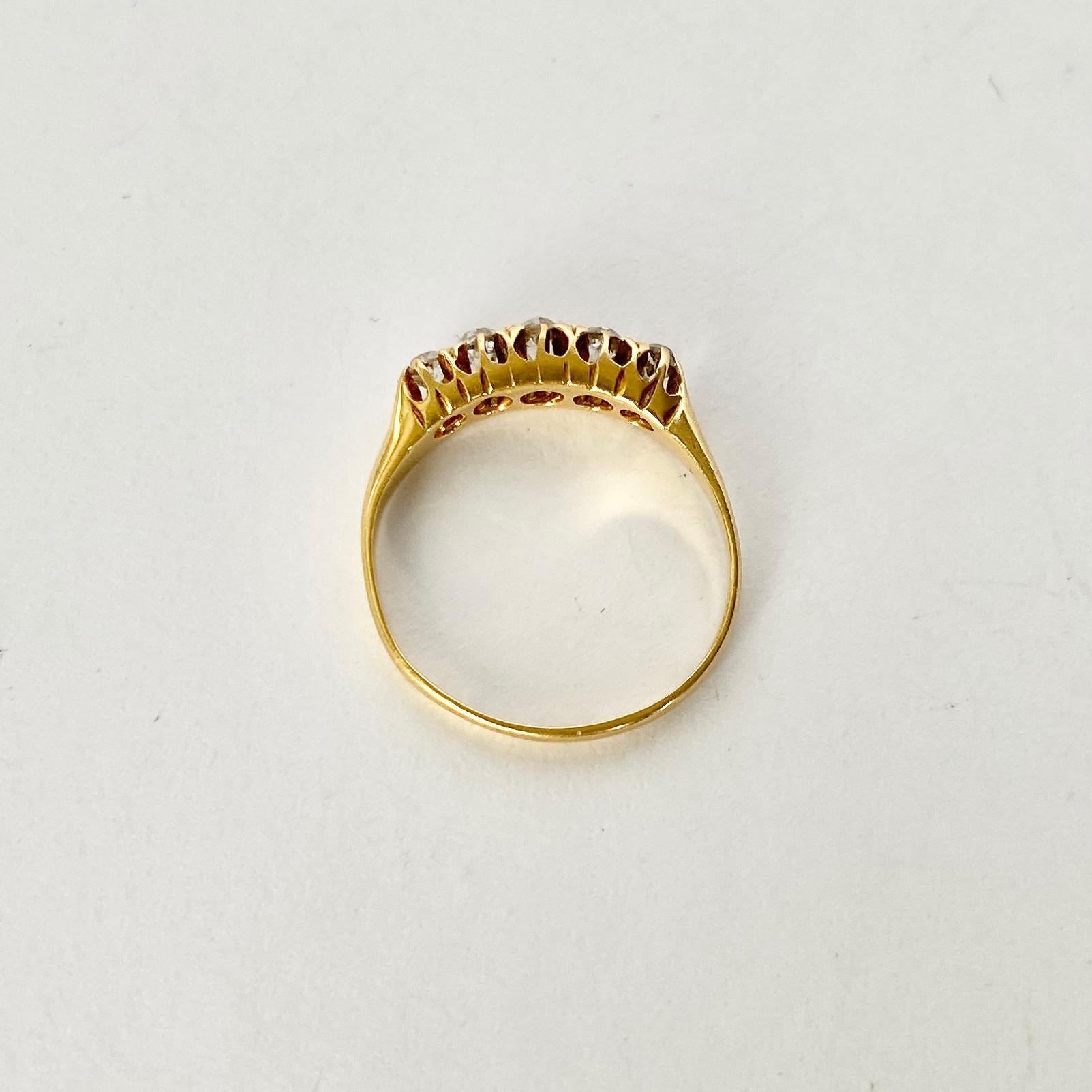 Five glistening diamonds sit fabulously on top of a simple setting modelled in 18ct gold. The old mine cut diamond total is 40pts. 

Ring Size: H 1/2 or 4
Width: 4mm
Height Off Finger: 4mm

Weight: 1.8g