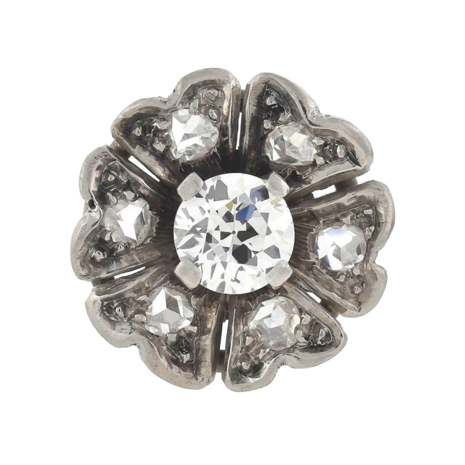 A stunning pair of diamond flower studs from the Edwardian (ca1910) era! Each earring is crafted in platinum and displays a sparkling diamond encrusted design. The 3-dimensional flowers have five curved petals, each one set with a gorgeous old Rose