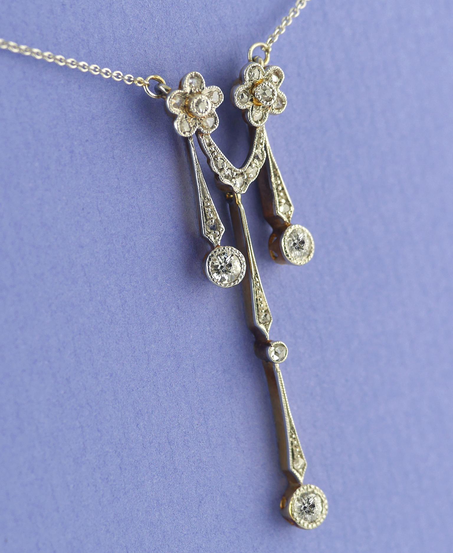 Edwardian Diamond Gold and Platinum Set Pendant circa 1910 on a platinum chain. 

Three principle diamonds, in articulated Edwardian drop collets, Victorian Old Cut (Old Mine) approx. 0.45 carat total.
Mix of old mine and rose cut diamonds in a