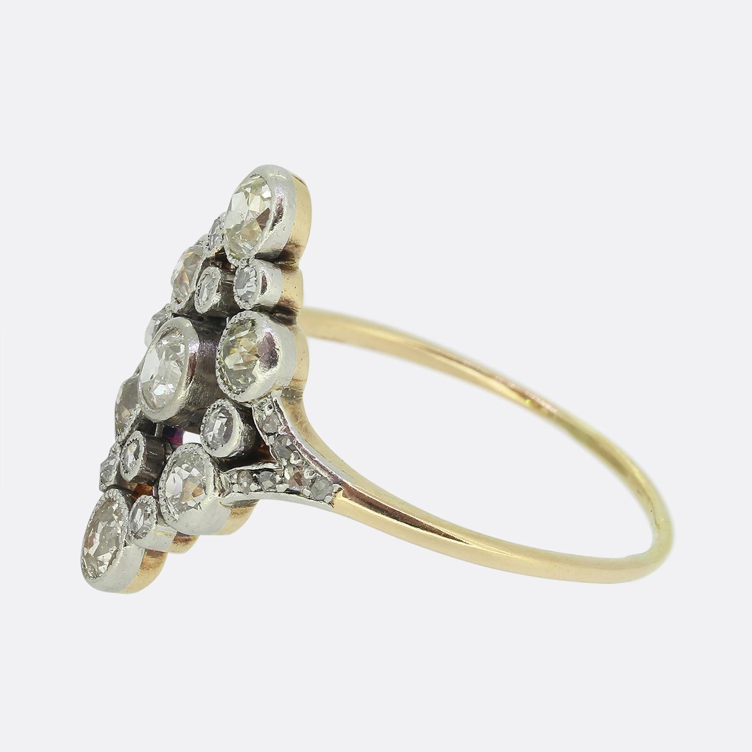 Here we have a lovely diamond navette ring dating back to the Edwardian period. An open platinum face plays host to an array of old mine and rose cut diamonds. Each stone has been individually milgrain set to collectively form this boat-like shape
