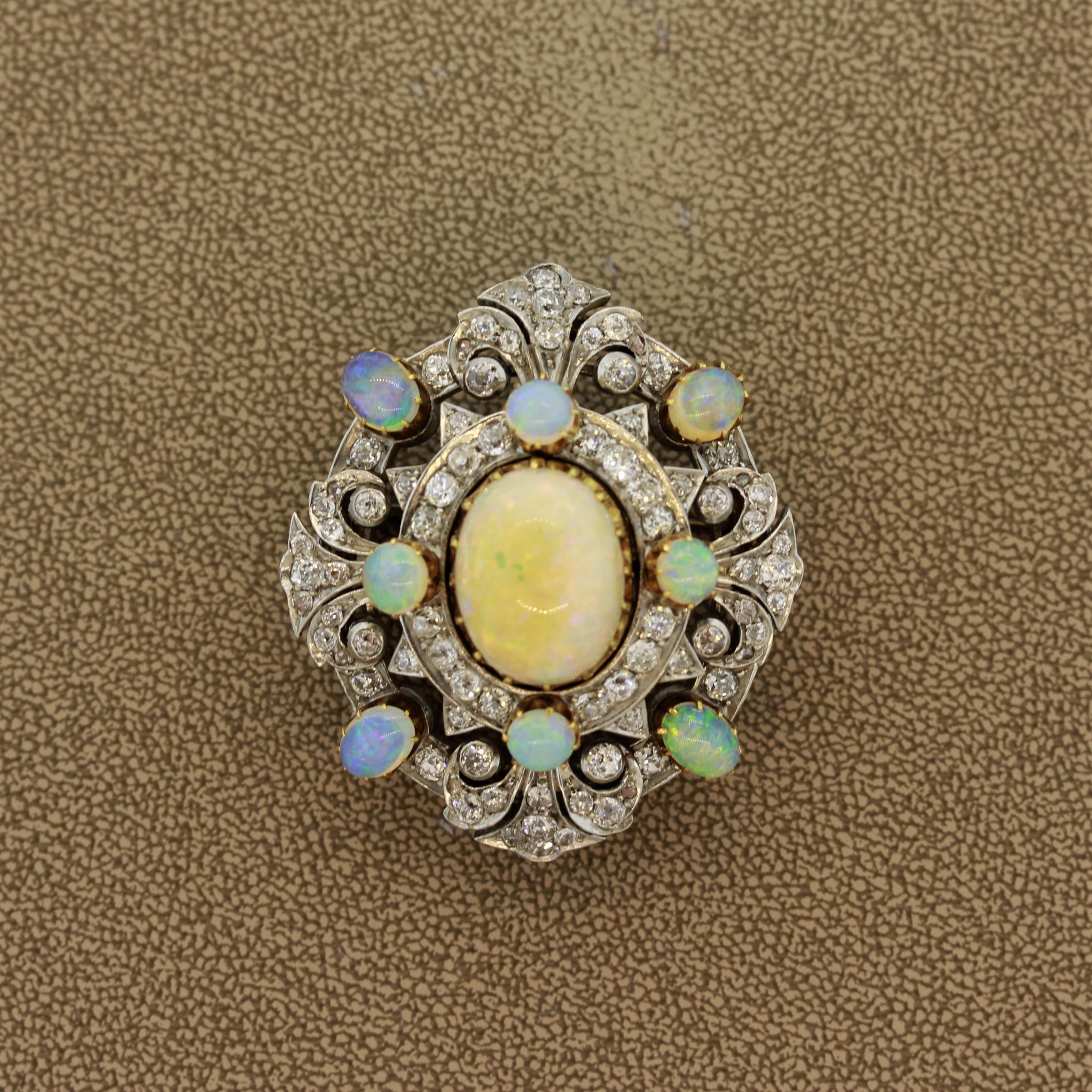 This early 1900’s treasure features 8 crystal opals and 1 large white opal in the center. It is accented by approximately 3 carats of old round european cut diamonds which are set in 14k gold. In classic Edwardian style the piece is platinum topped